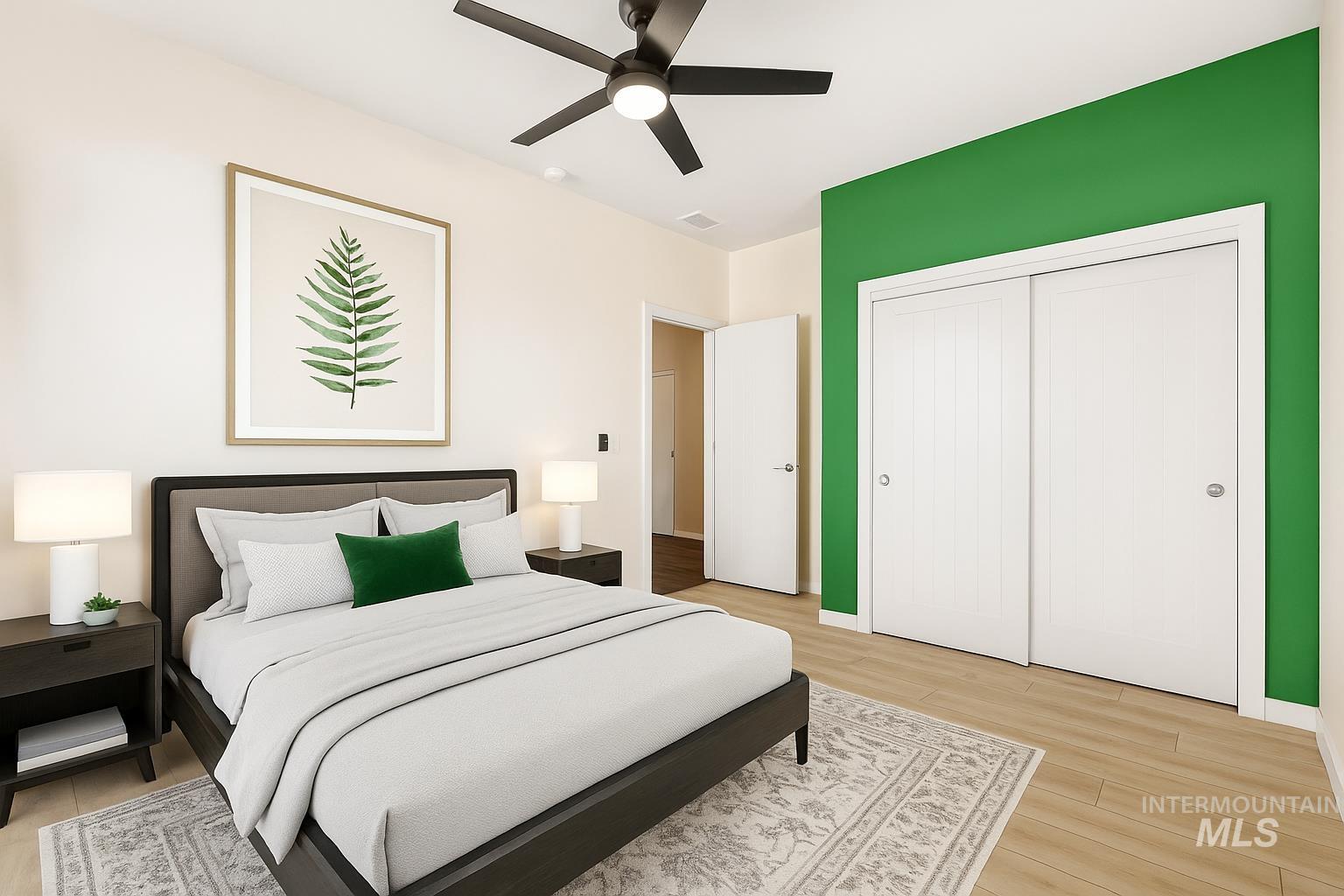 Bedroom with light wood-type flooring, ceiling fan, and a closet