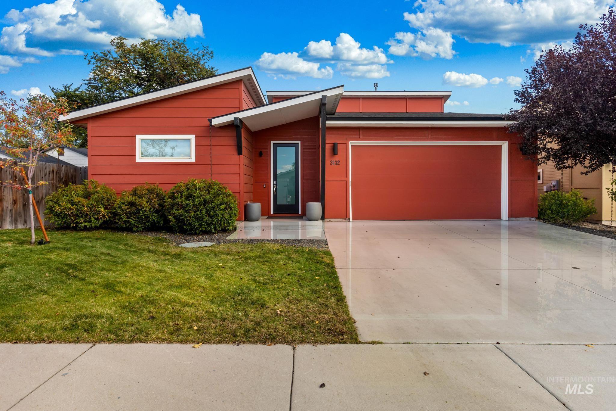View of front facade with concrete driveway and an attached garage