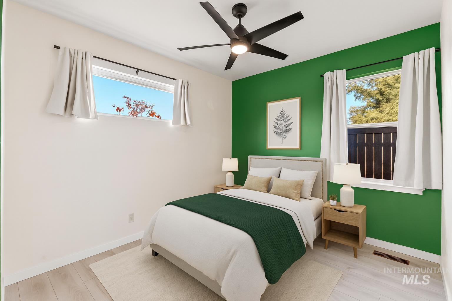 Bedroom with wood finished floors and ceiling fan