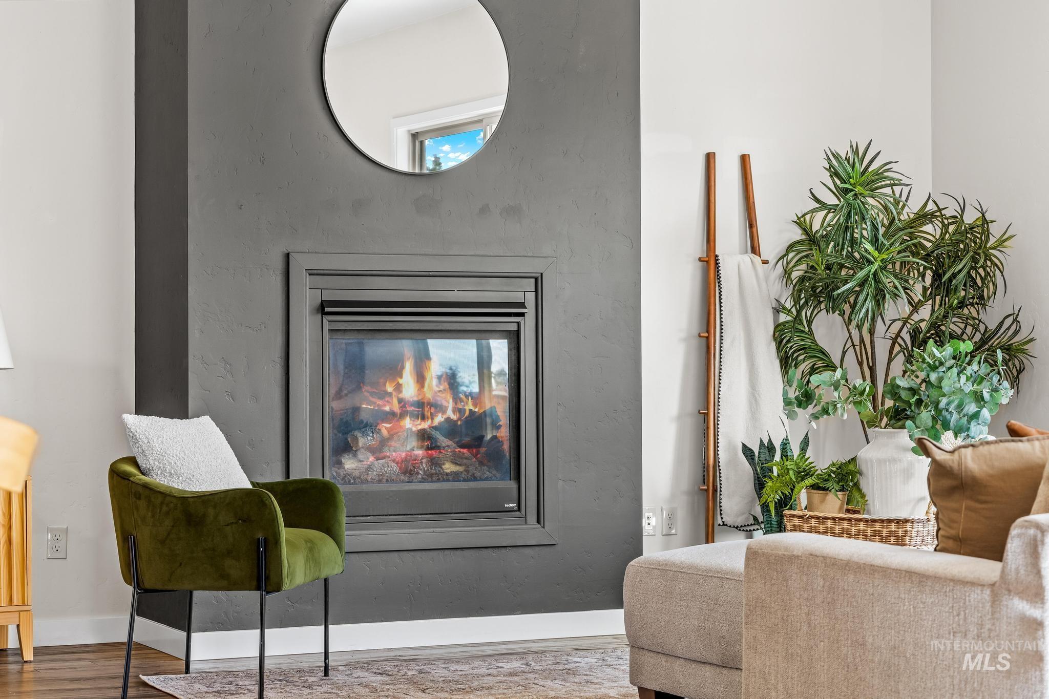 Living area with wood finished floors and a fireplace