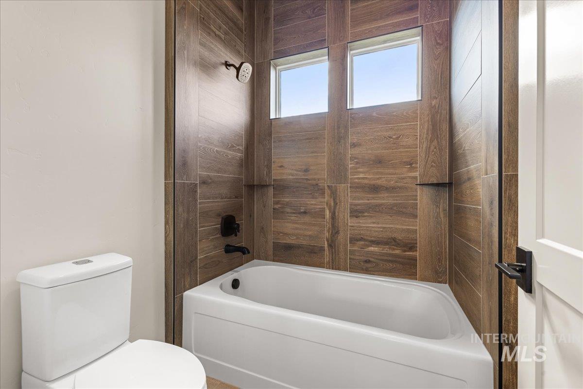 Bathroom featuring shower / bath combination and toilet