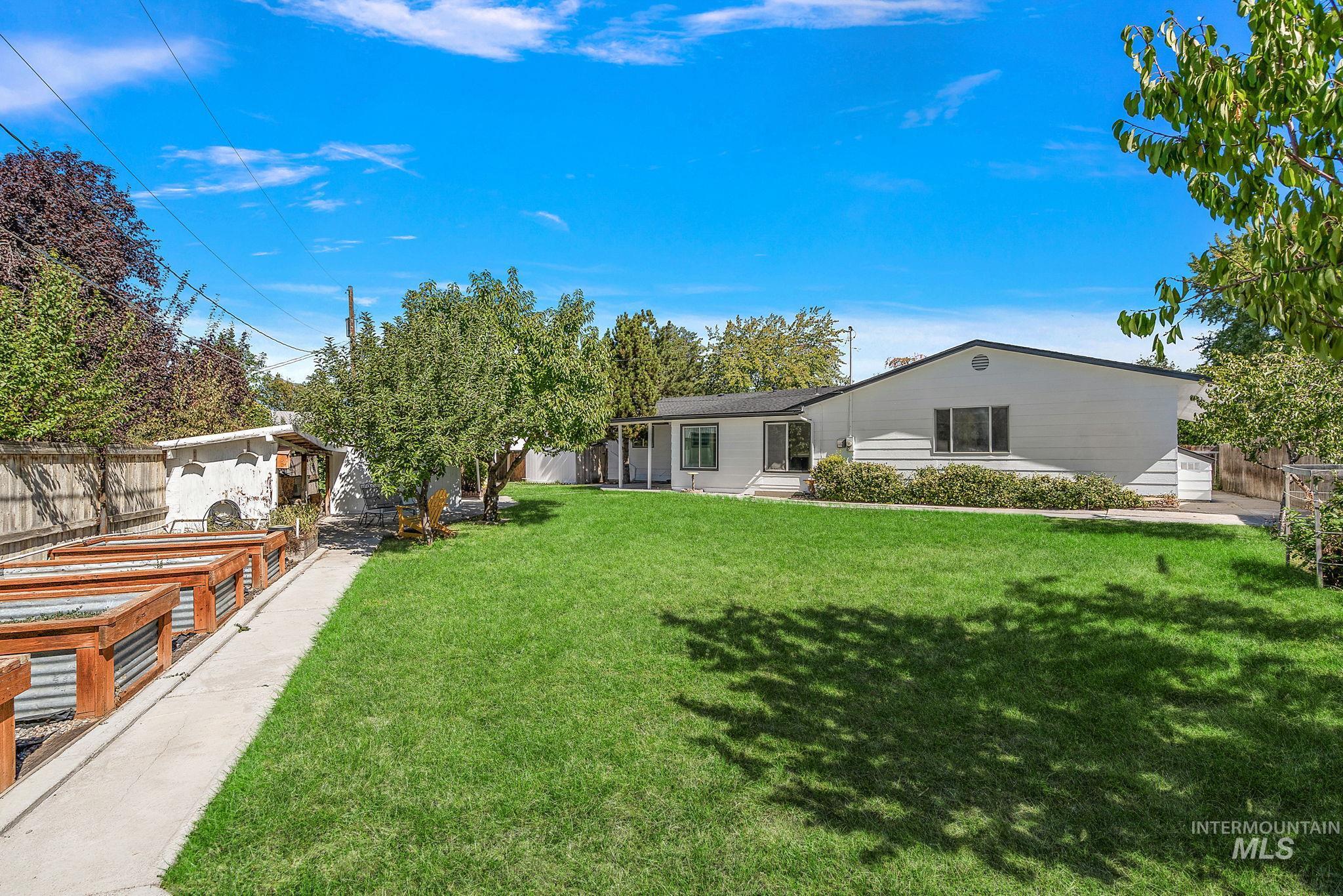 View of yard with an outbuilding and a vegetable garden