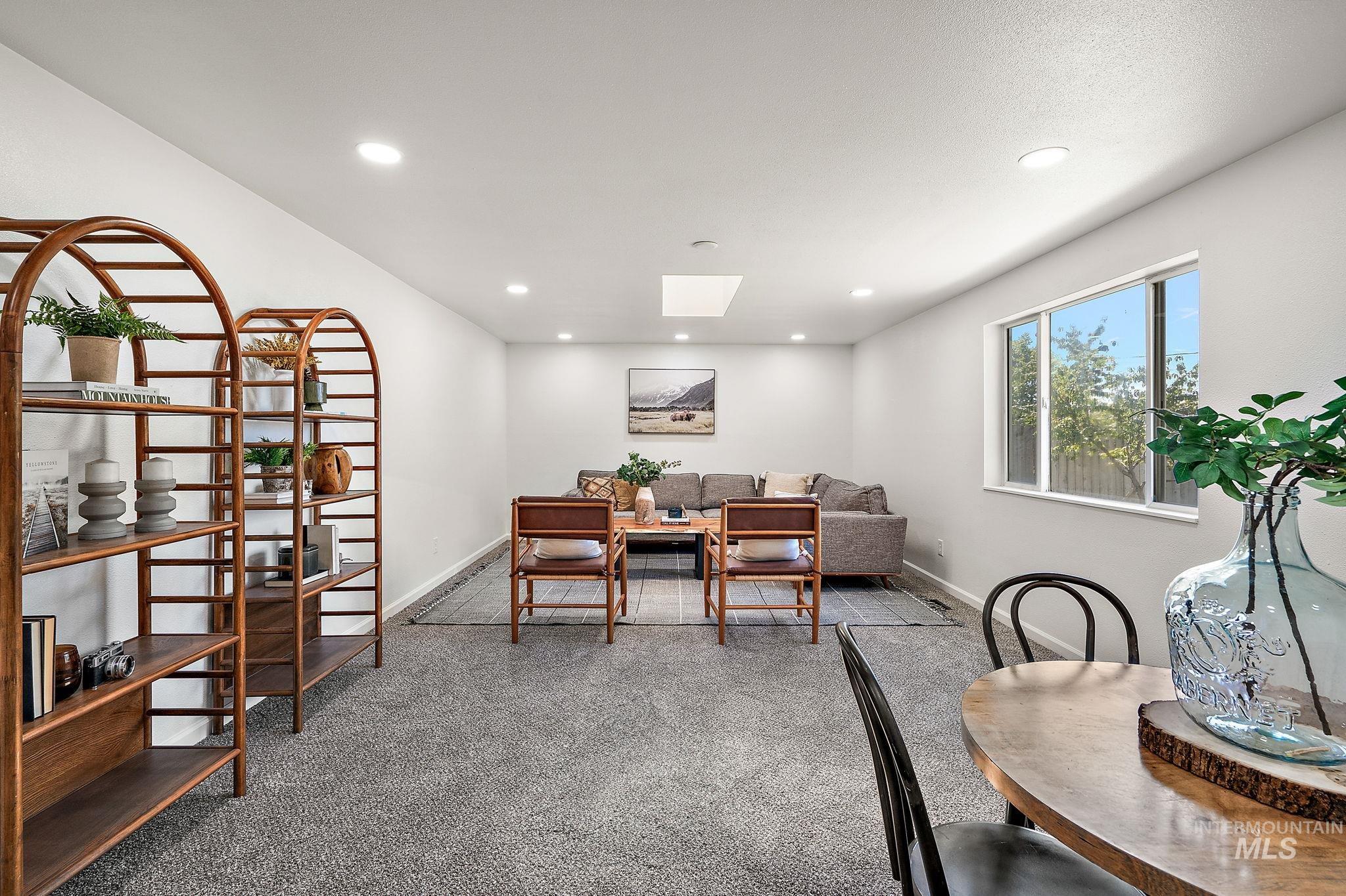 Carpeted office space featuring a skylight and recessed lighting