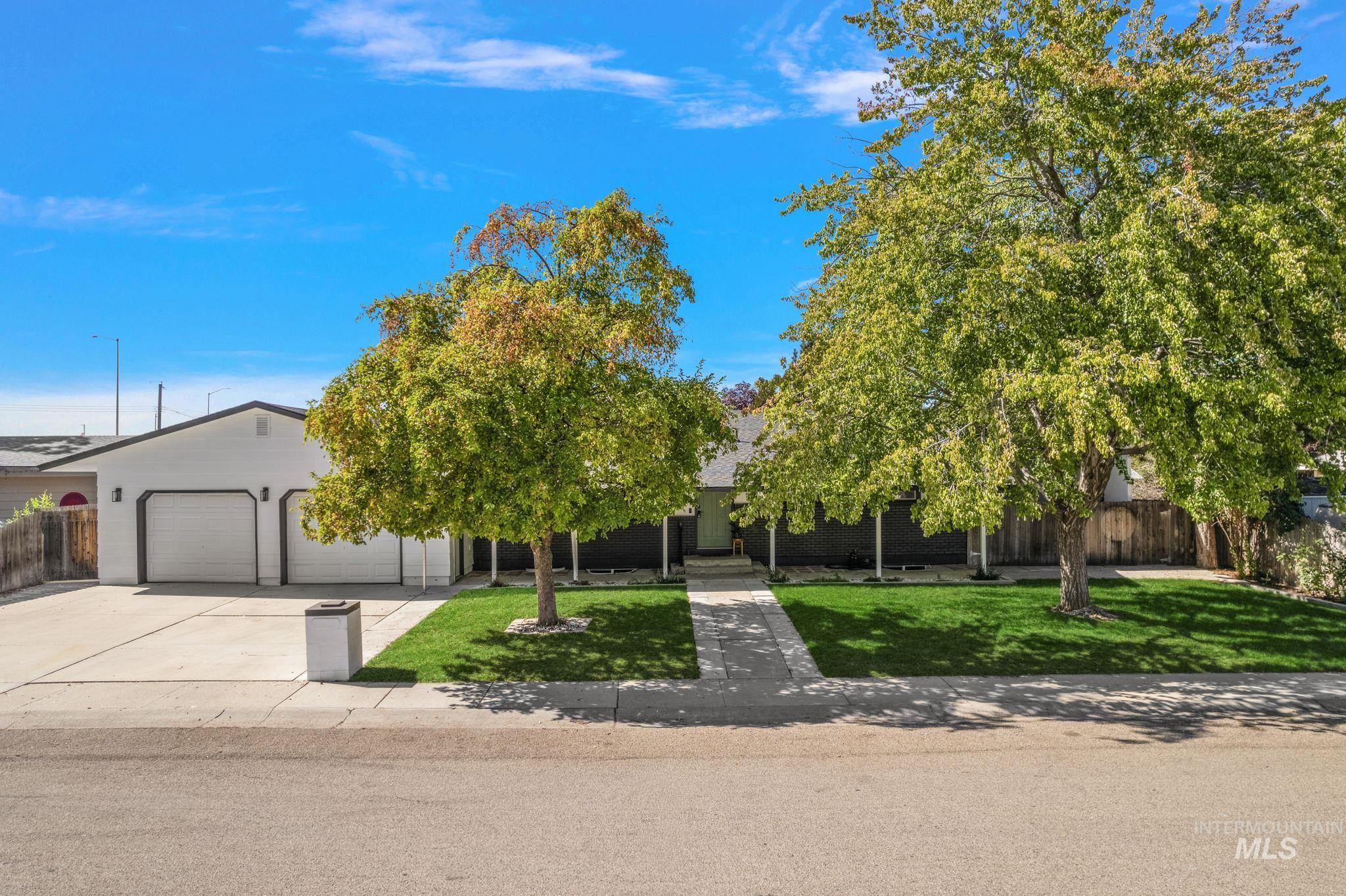 Obstructed view of property featuring driveway and an attached garage