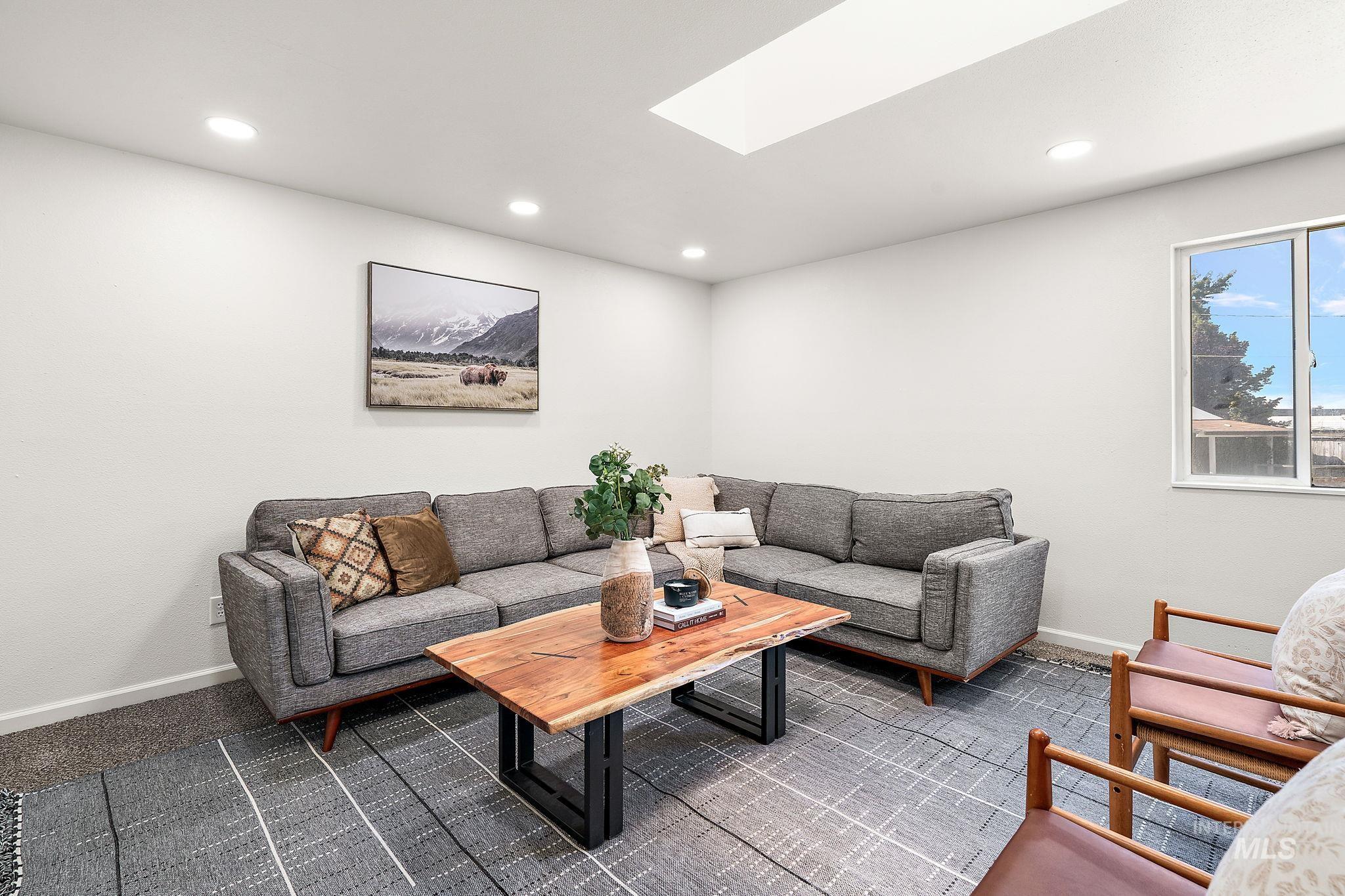 Living area featuring a skylight and recessed lighting