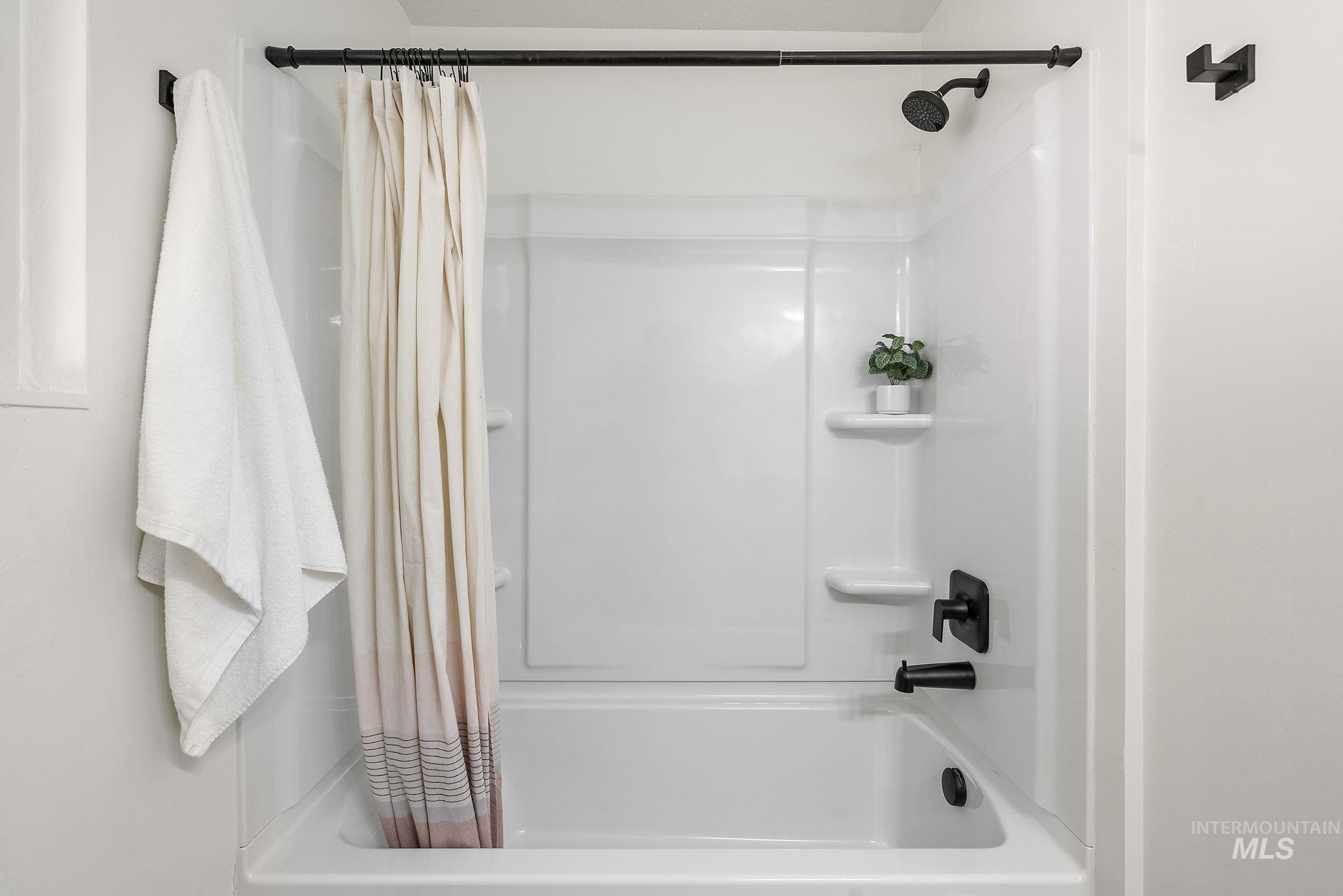 Full bathroom with shower / bathtub combination with curtain