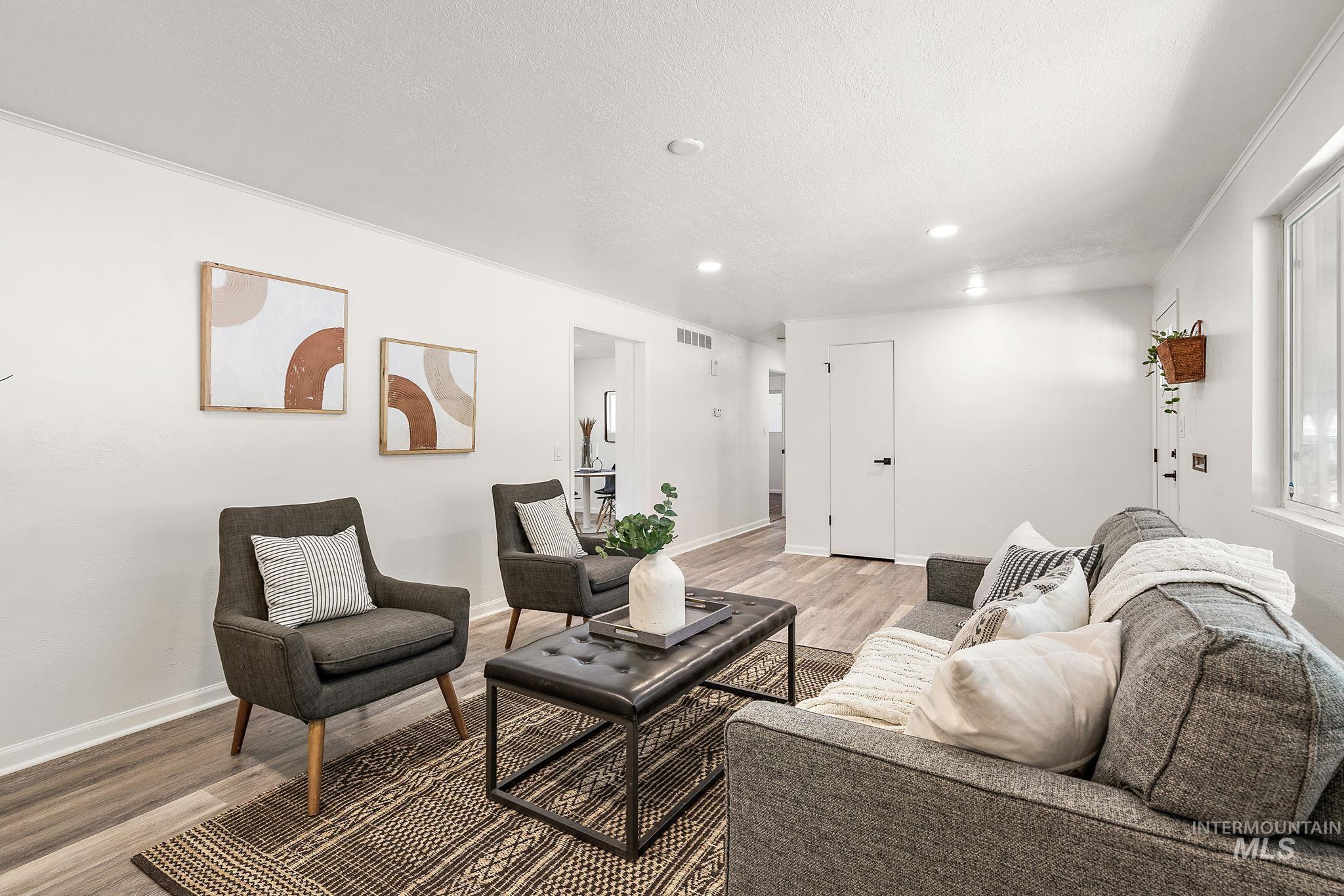 Living area featuring wood finished floors, recessed lighting, and a textured ceiling