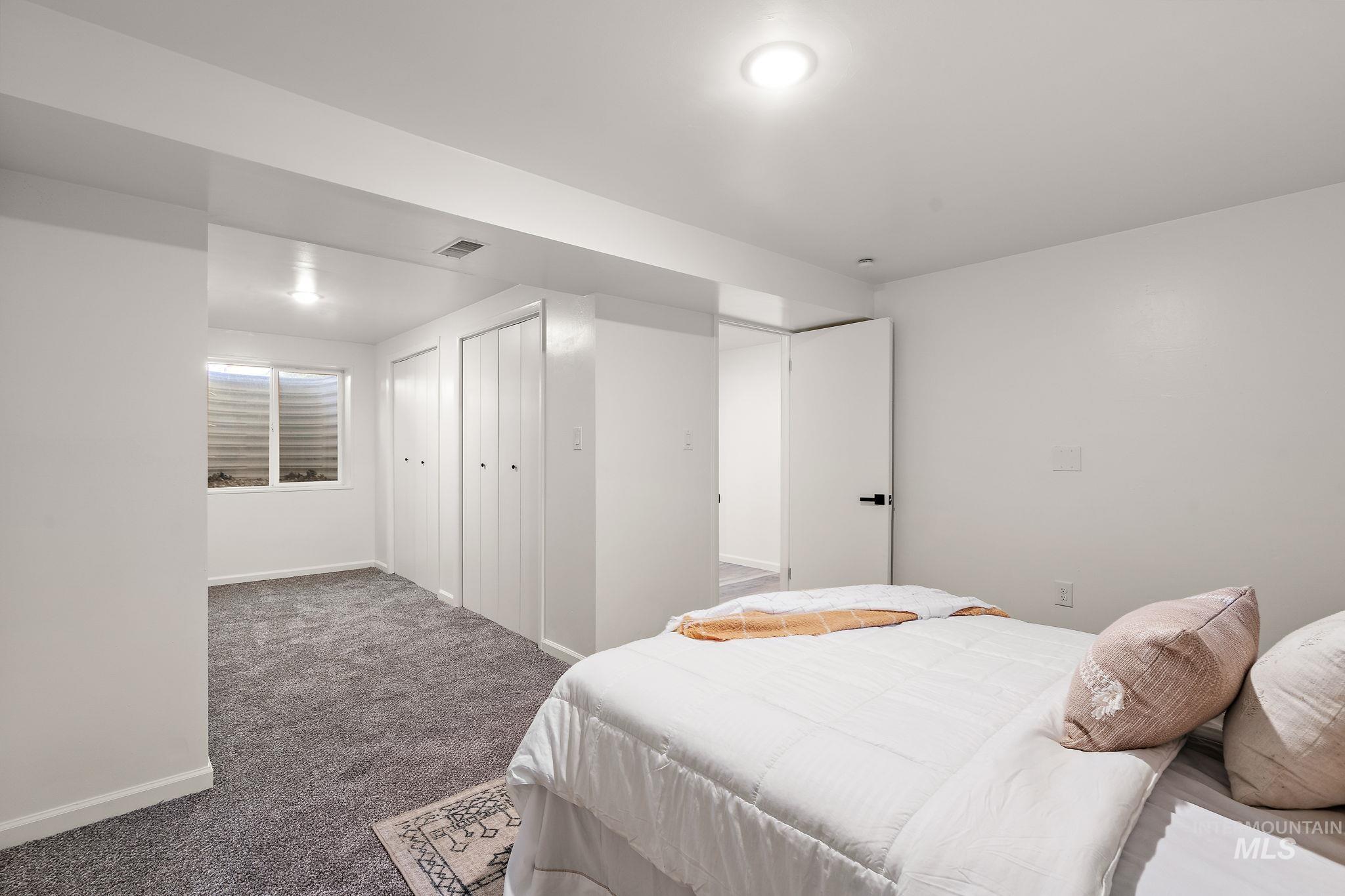 Carpeted bedroom featuring baseboards and a closet
