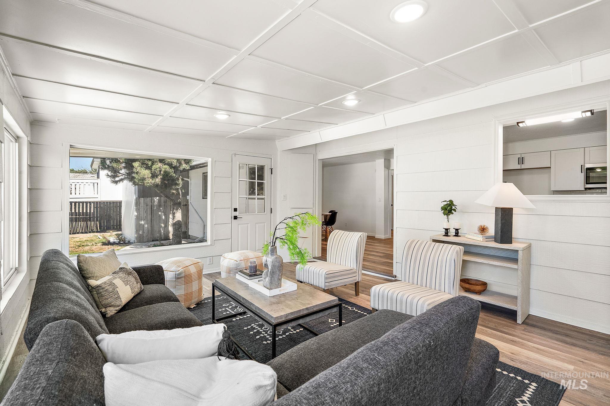 Living room featuring wood finished floors, recessed lighting, and wood walls