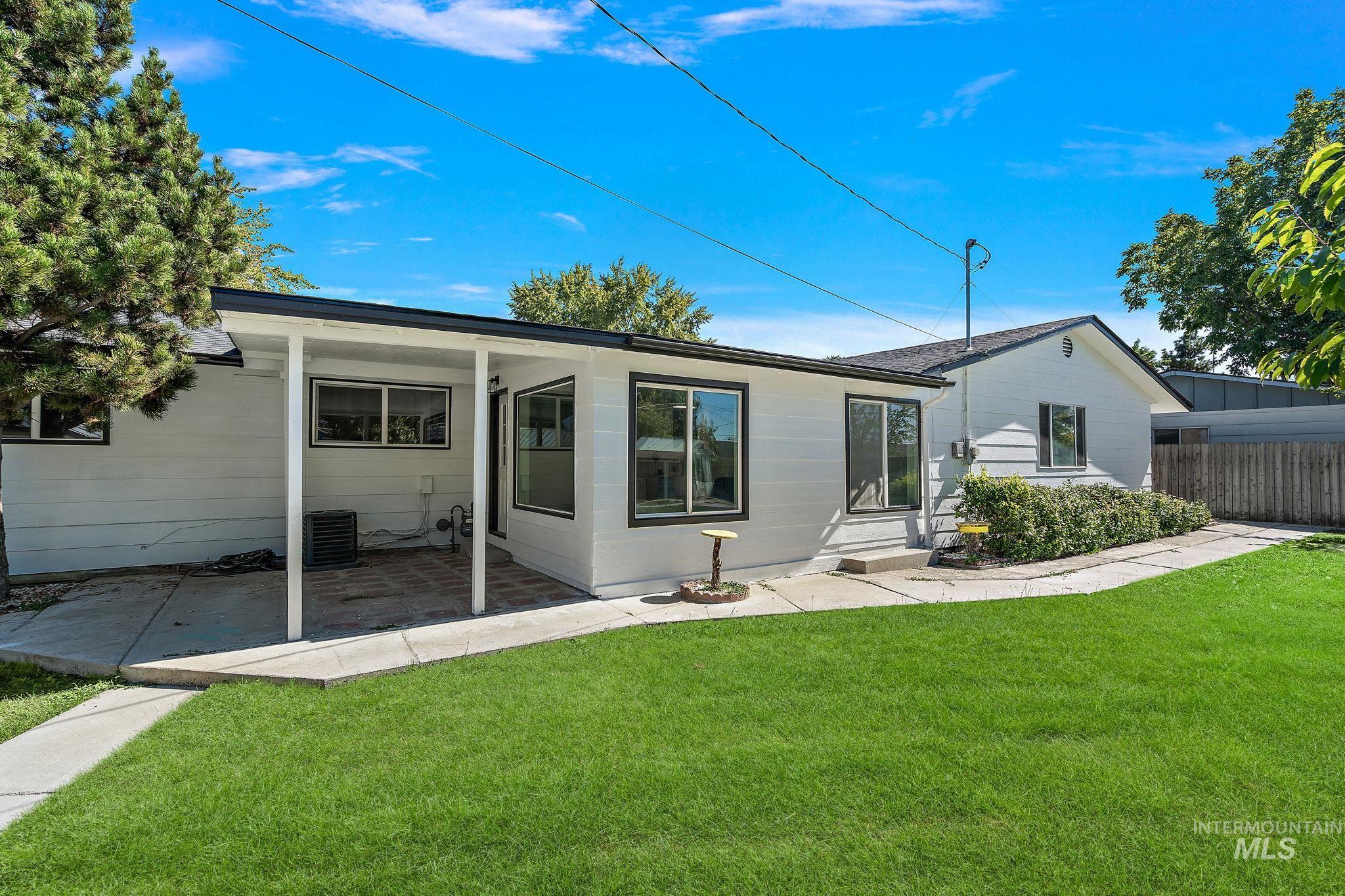Rear view of house with a patio area and roof with shingles