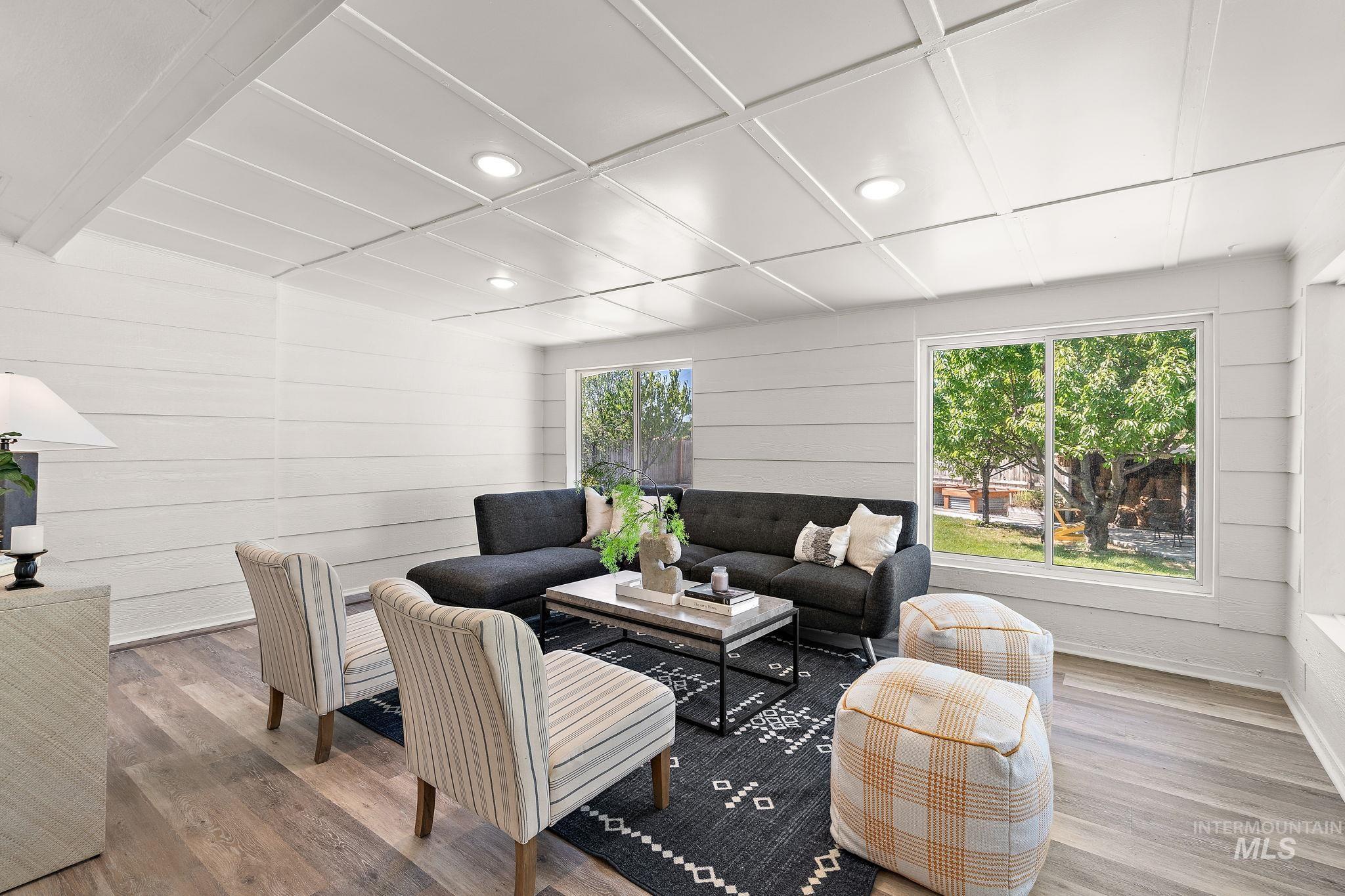 Living area featuring recessed lighting, wood finished floors, and wooden walls