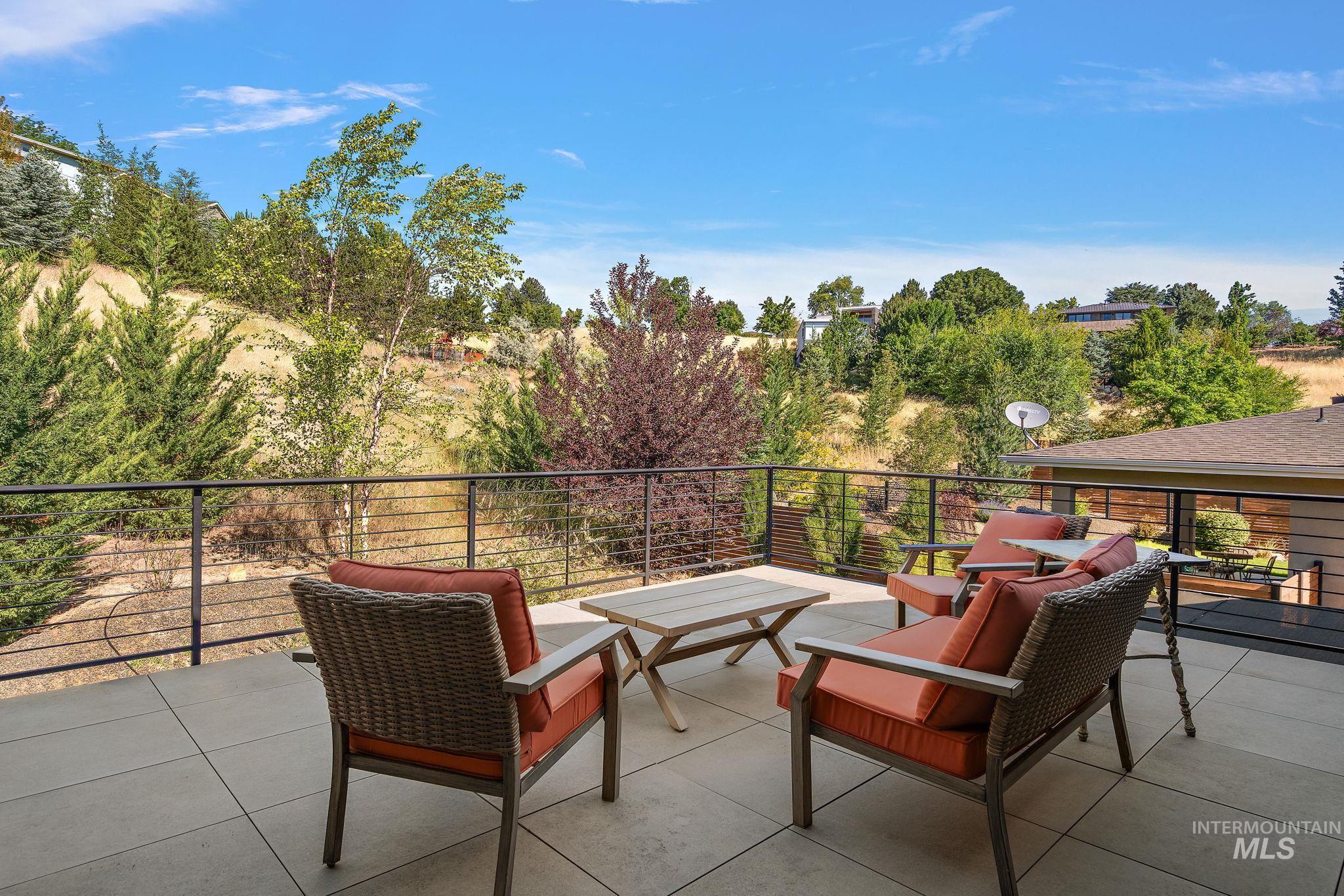 Expansive outdoor terrace featuring large format tile flooring and a sleek cable railing system