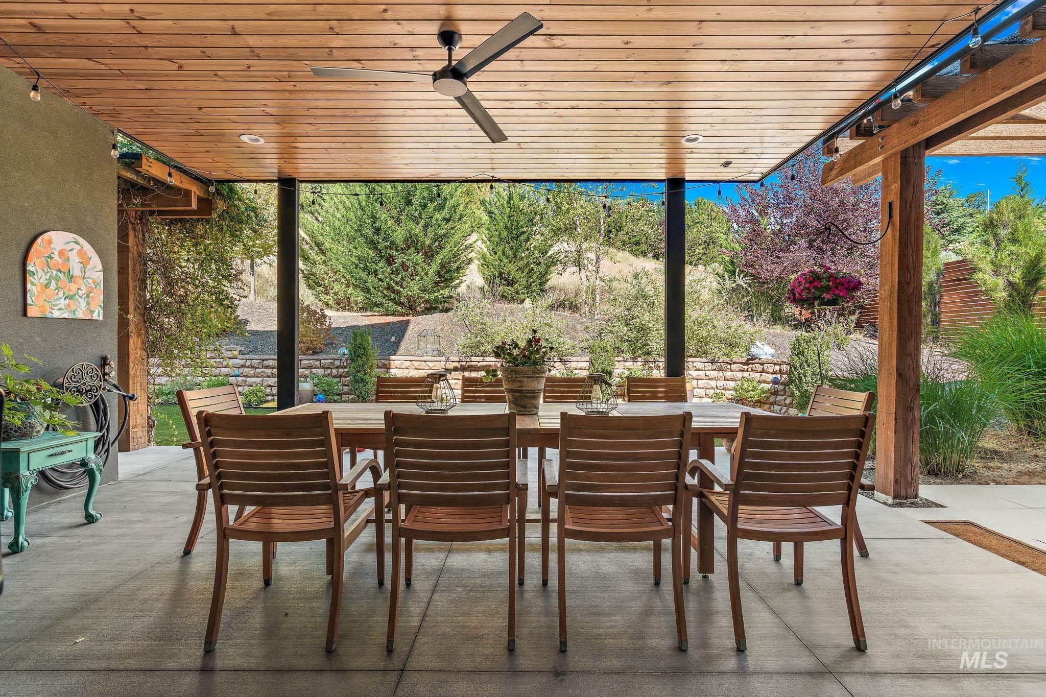 Covered patio with a wood-finish ceiling, integrated ceiling fan, and recessed lighting