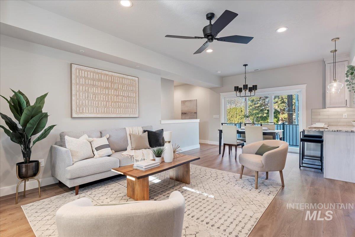 Living room featuring recessed lighting, light wood finished floors, and a ceiling fan