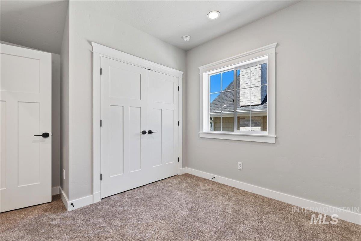 Unfurnished bedroom featuring carpet floors and a closet