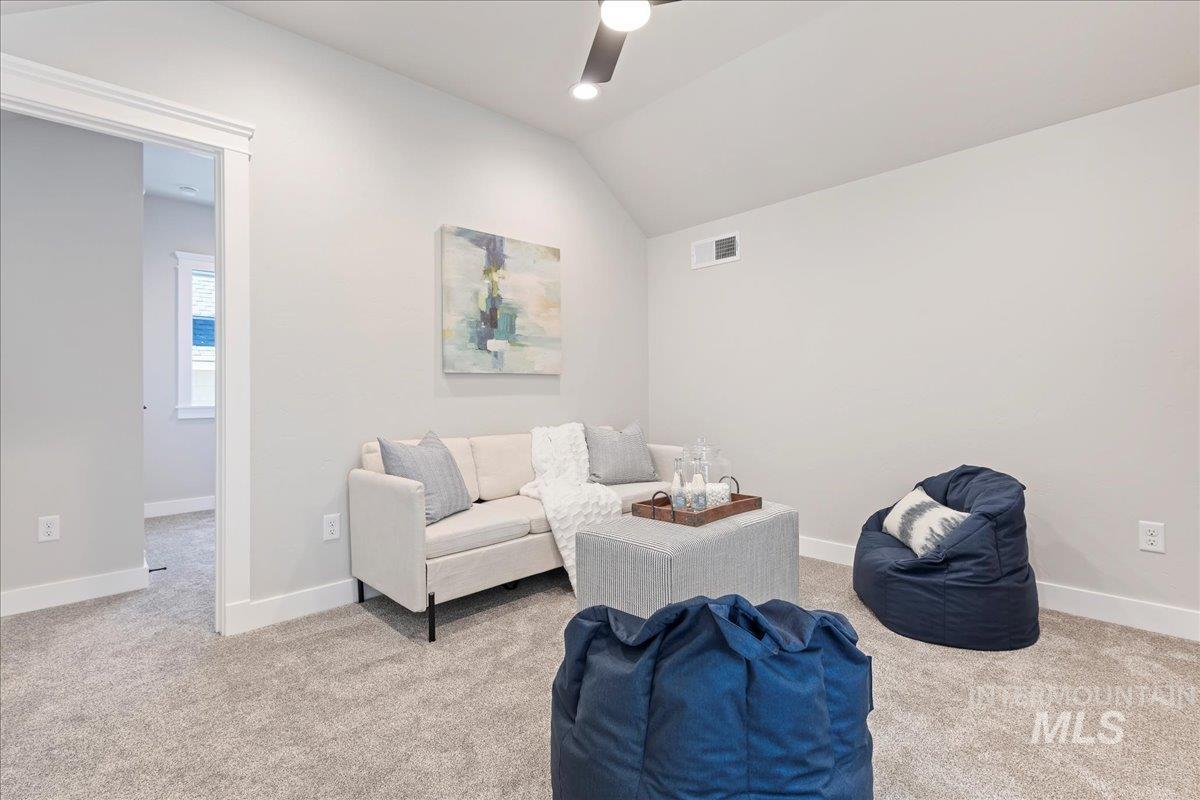 Living area featuring lofted ceiling, carpet floors, recessed lighting, and ceiling fan