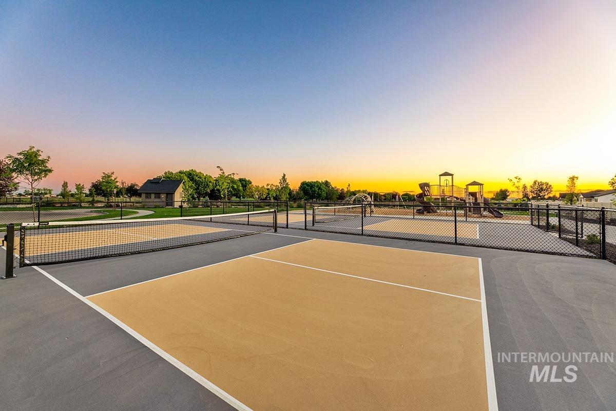 View of tennis court with community basketball court