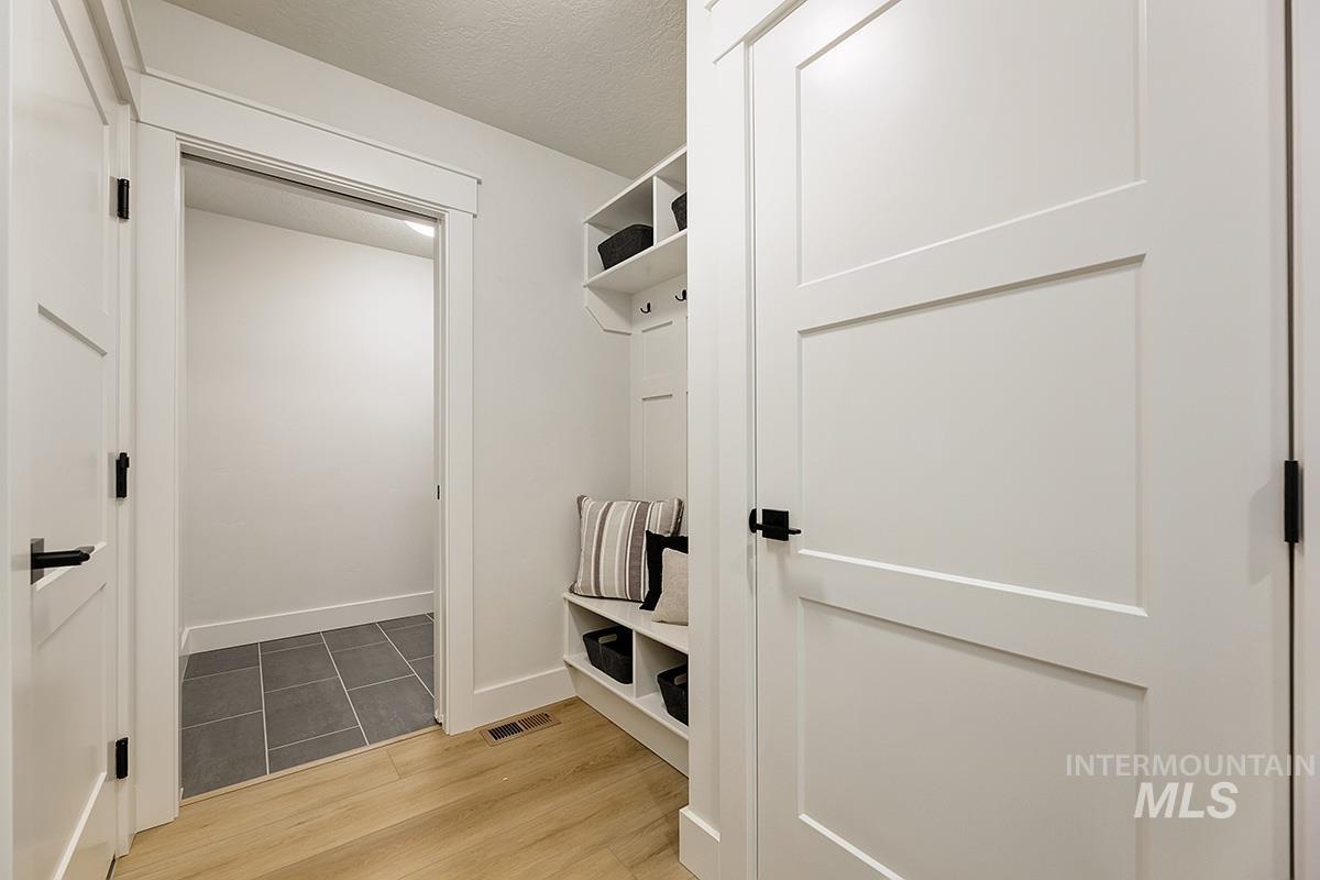 Built-in mudroom bench with cubby storage and coat hooks