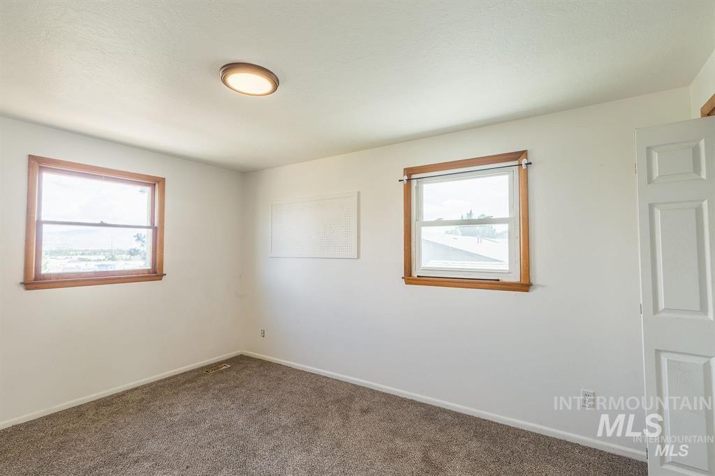 Empty room with carpet and baseboards