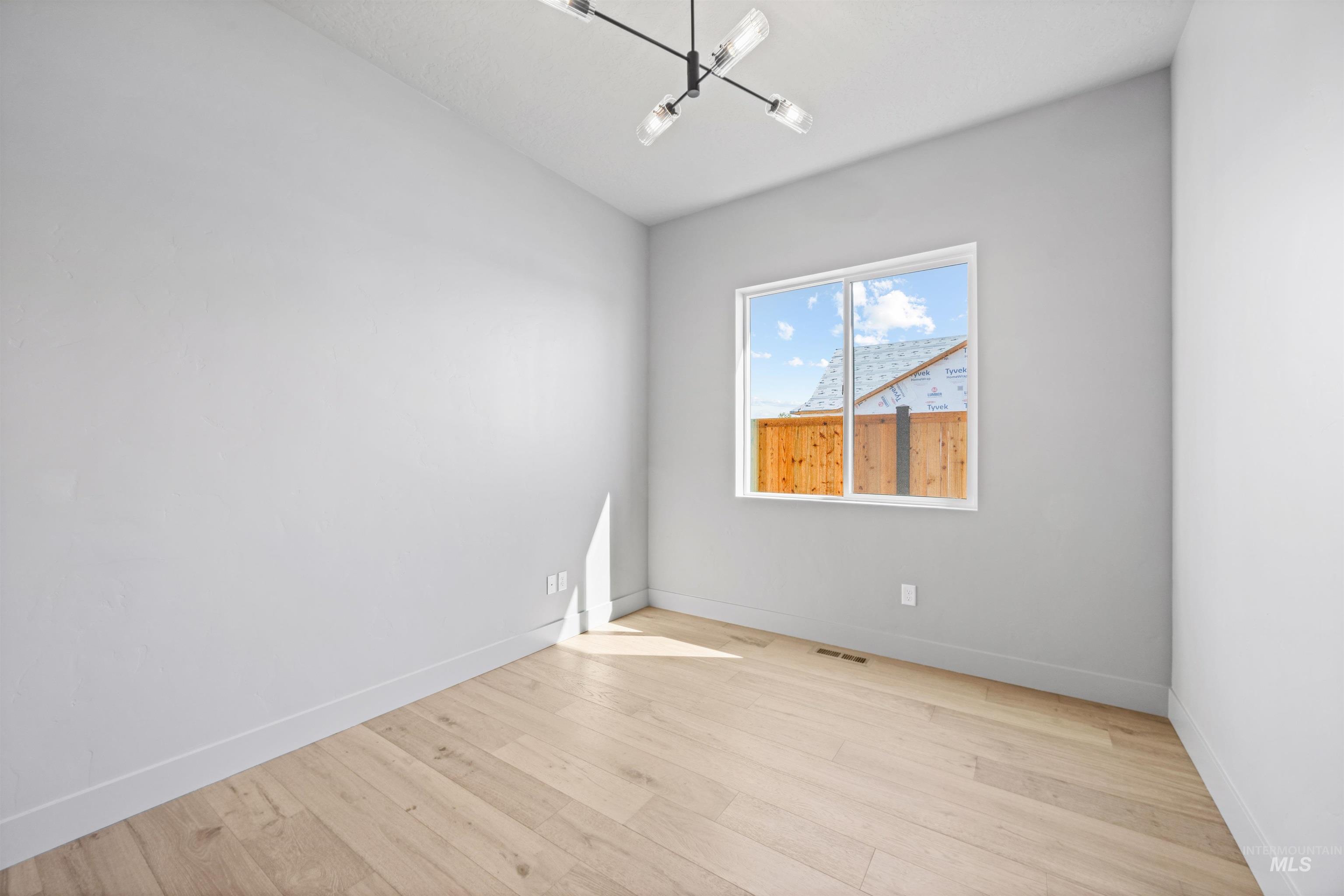 Unfurnished room featuring light wood-style floors and baseboards