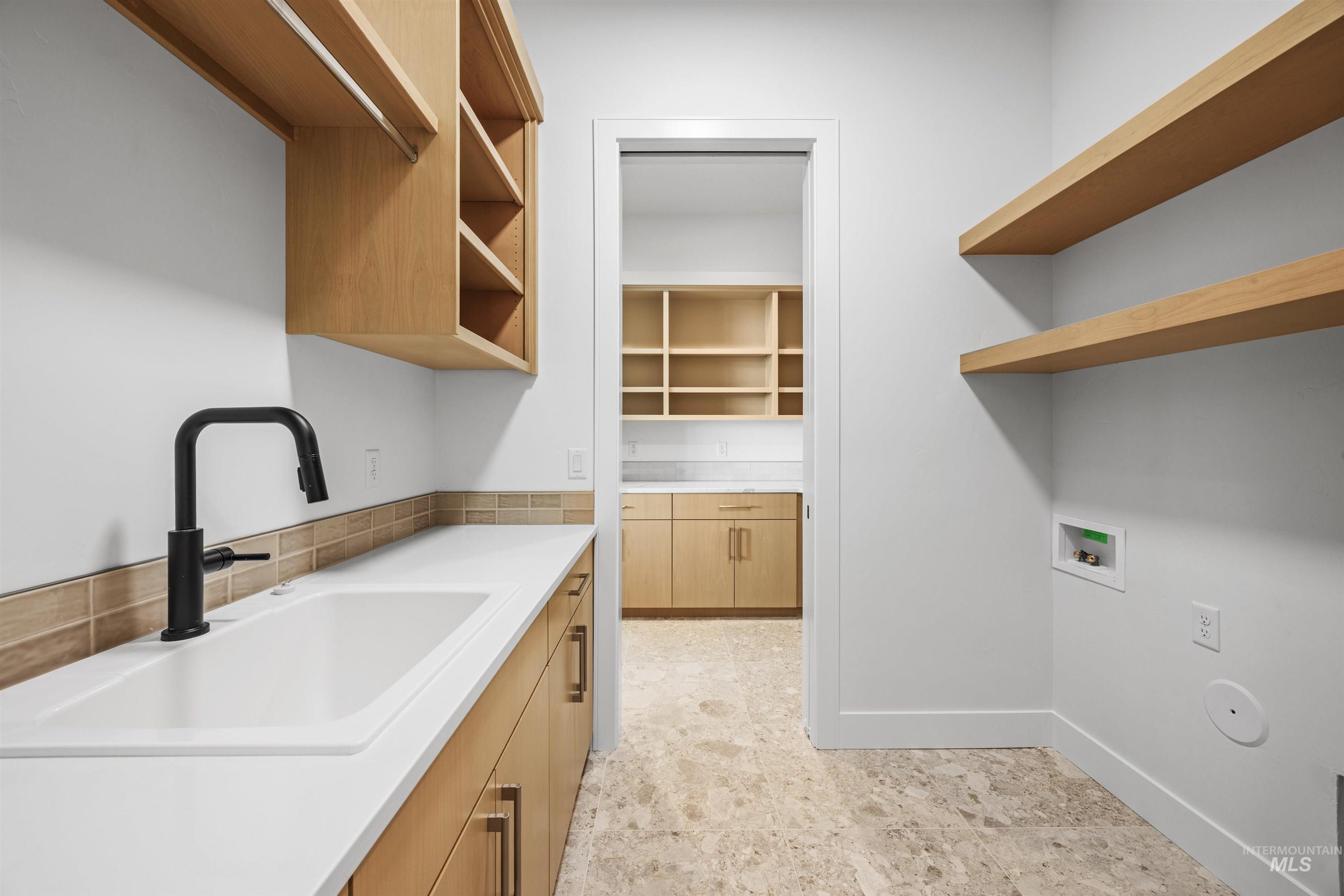 Laundry area with hookup for a washing machine and cabinet space