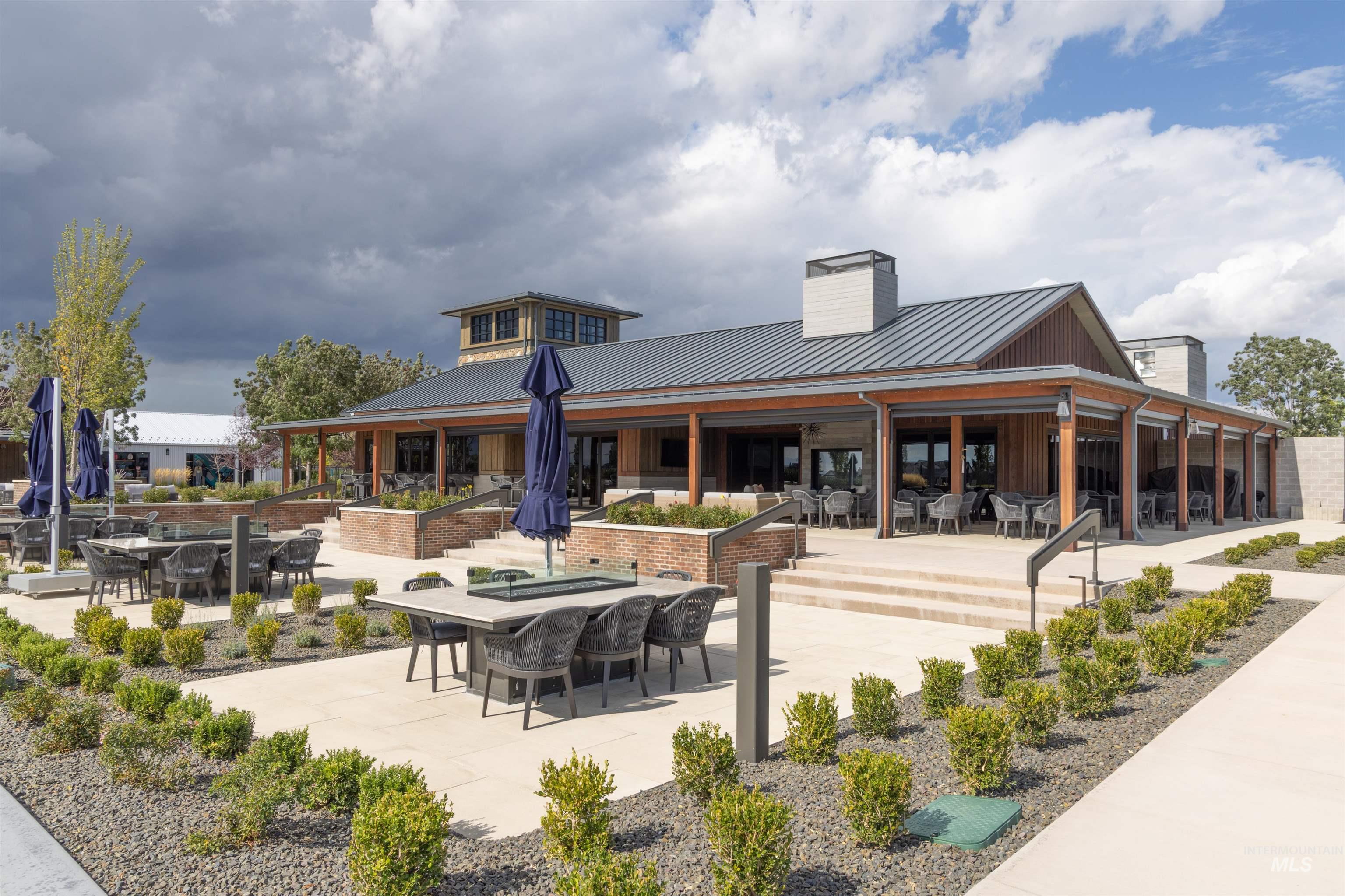 View of community featuring a patio area and outdoor dining area