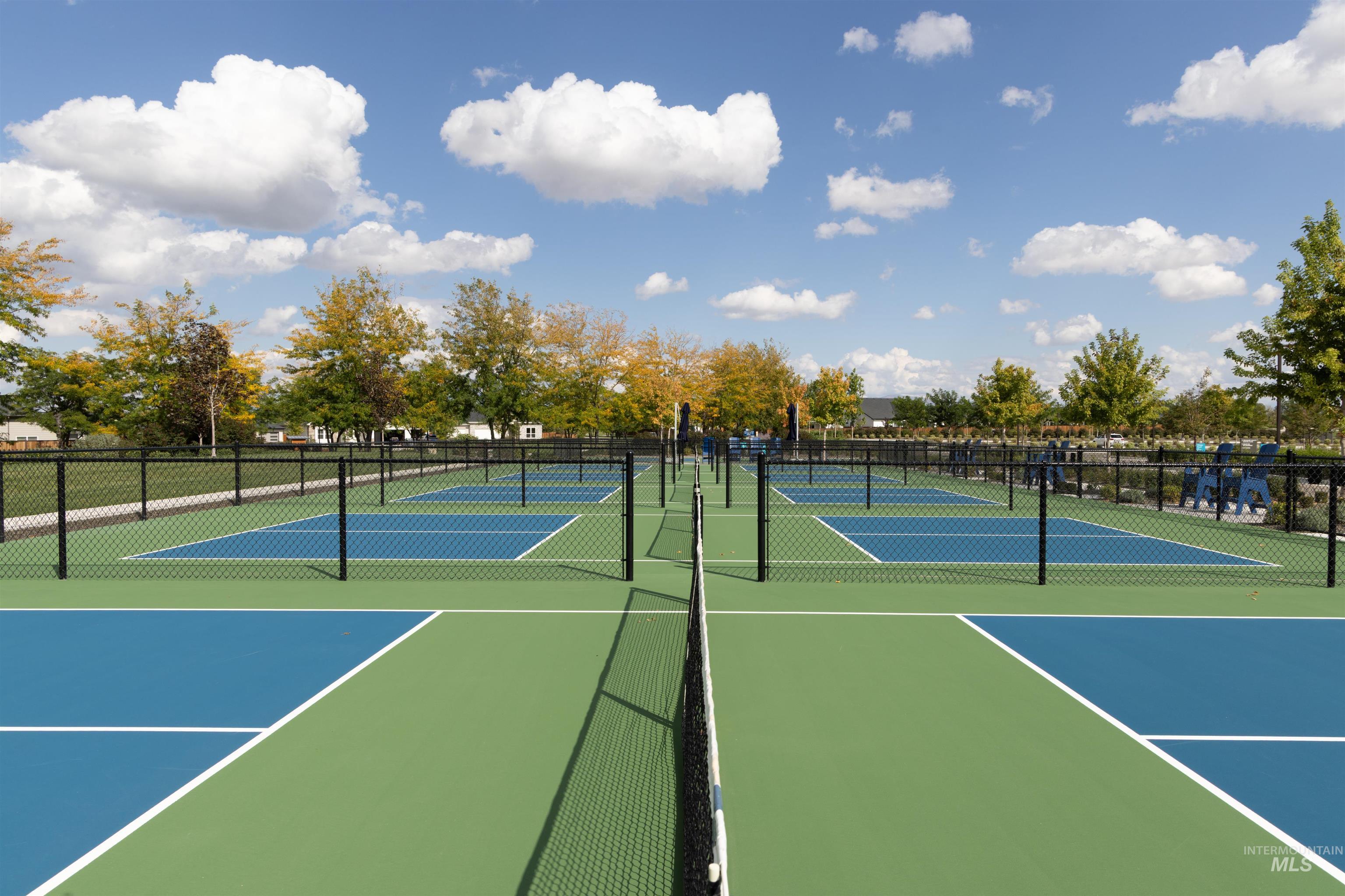 View of tennis court featuring community basketball court