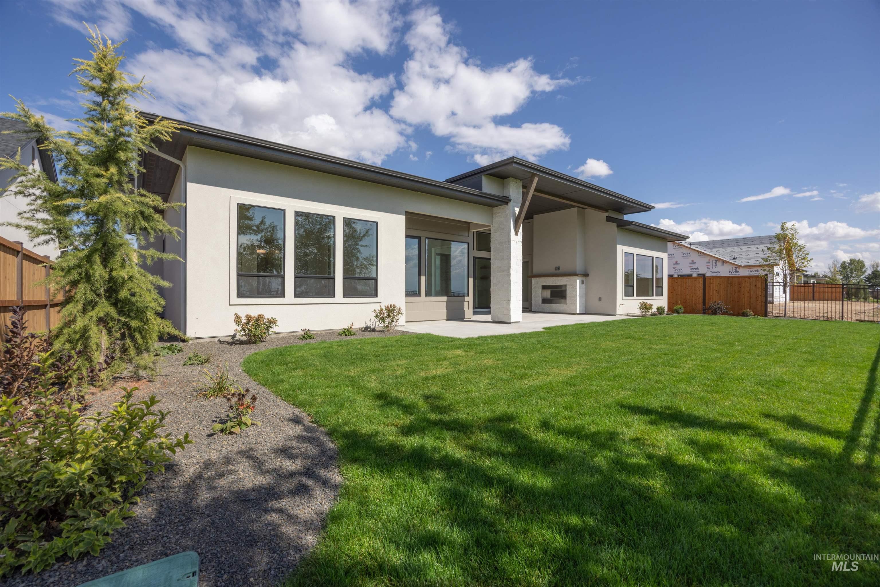 Back of property with a fenced backyard, a patio area, and stucco siding