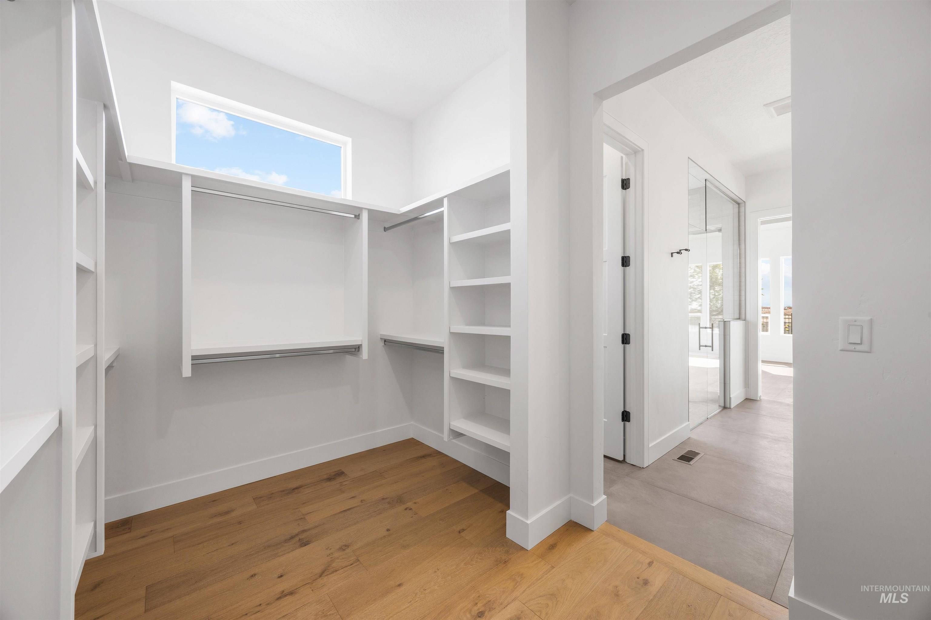 Walk in closet featuring light wood-style floors