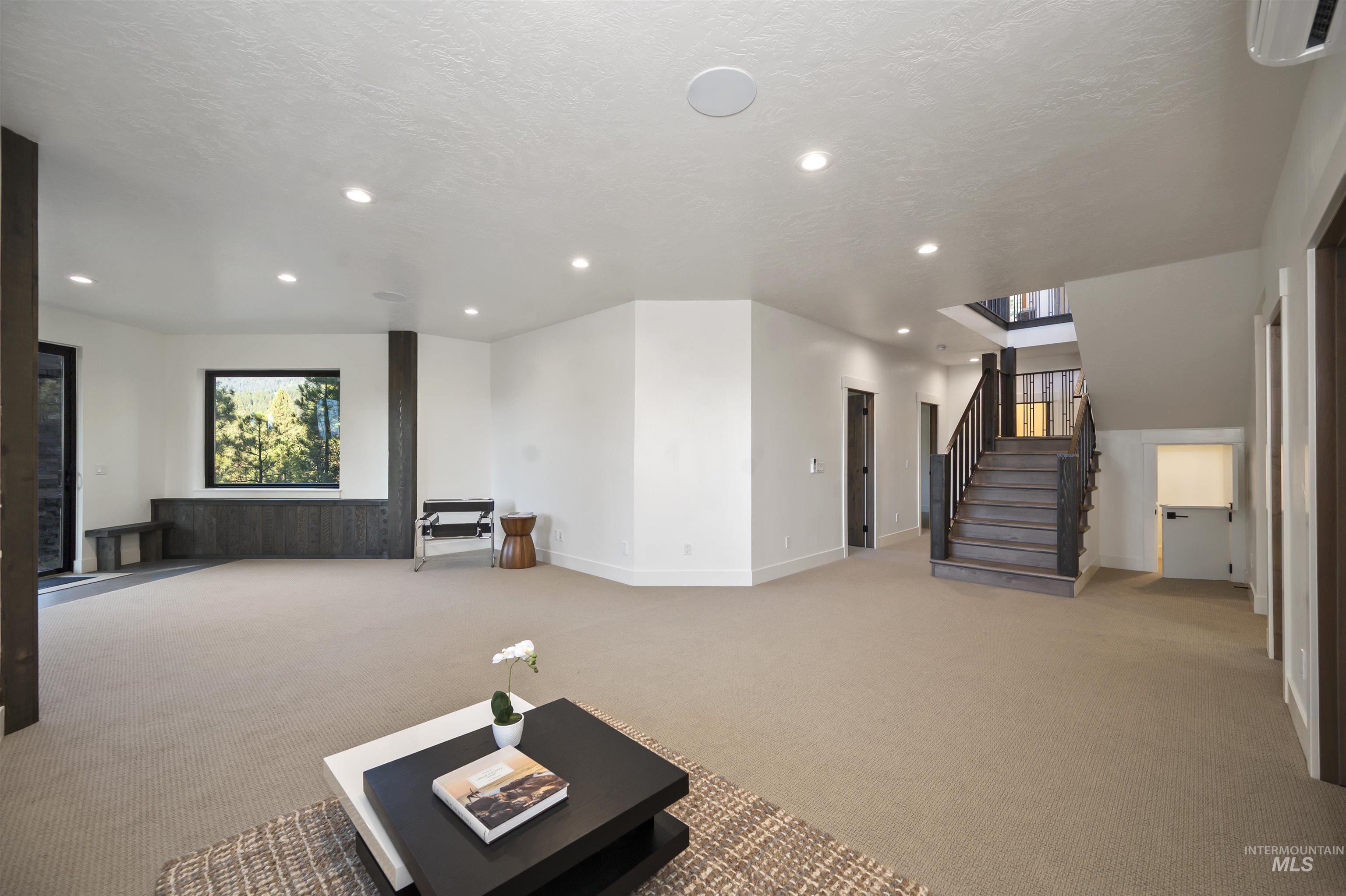 Home theater room with light colored carpet and recessed lighting