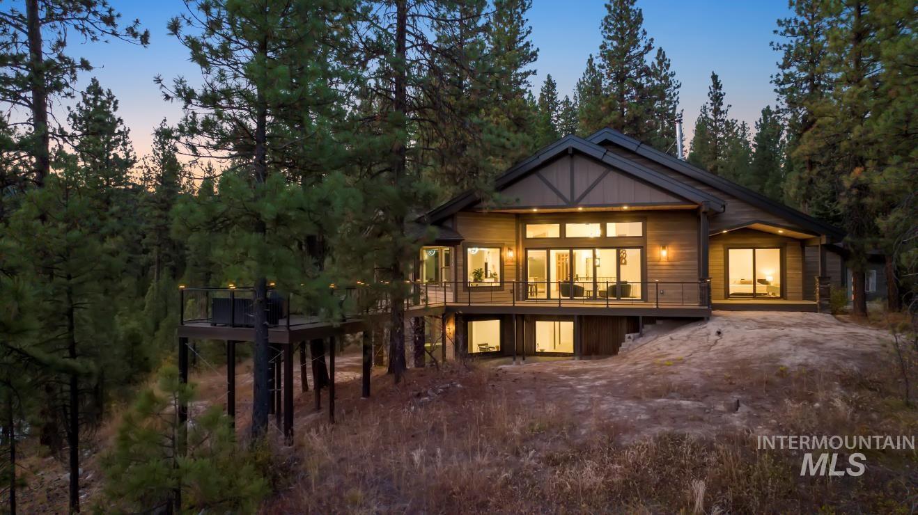 Back of house at dusk with a deck