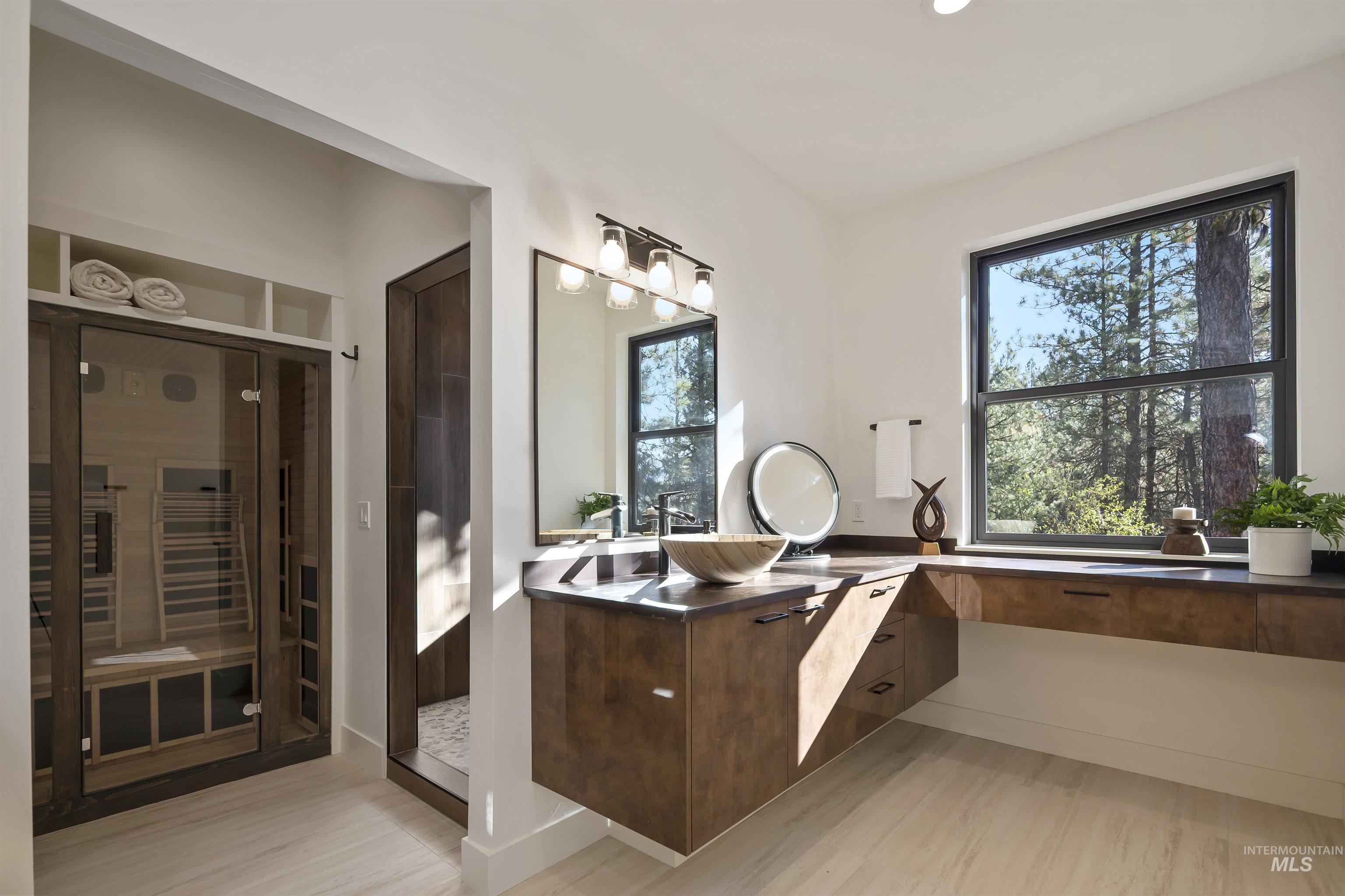 Bathroom featuring a sauna, vanity, and a shower stall