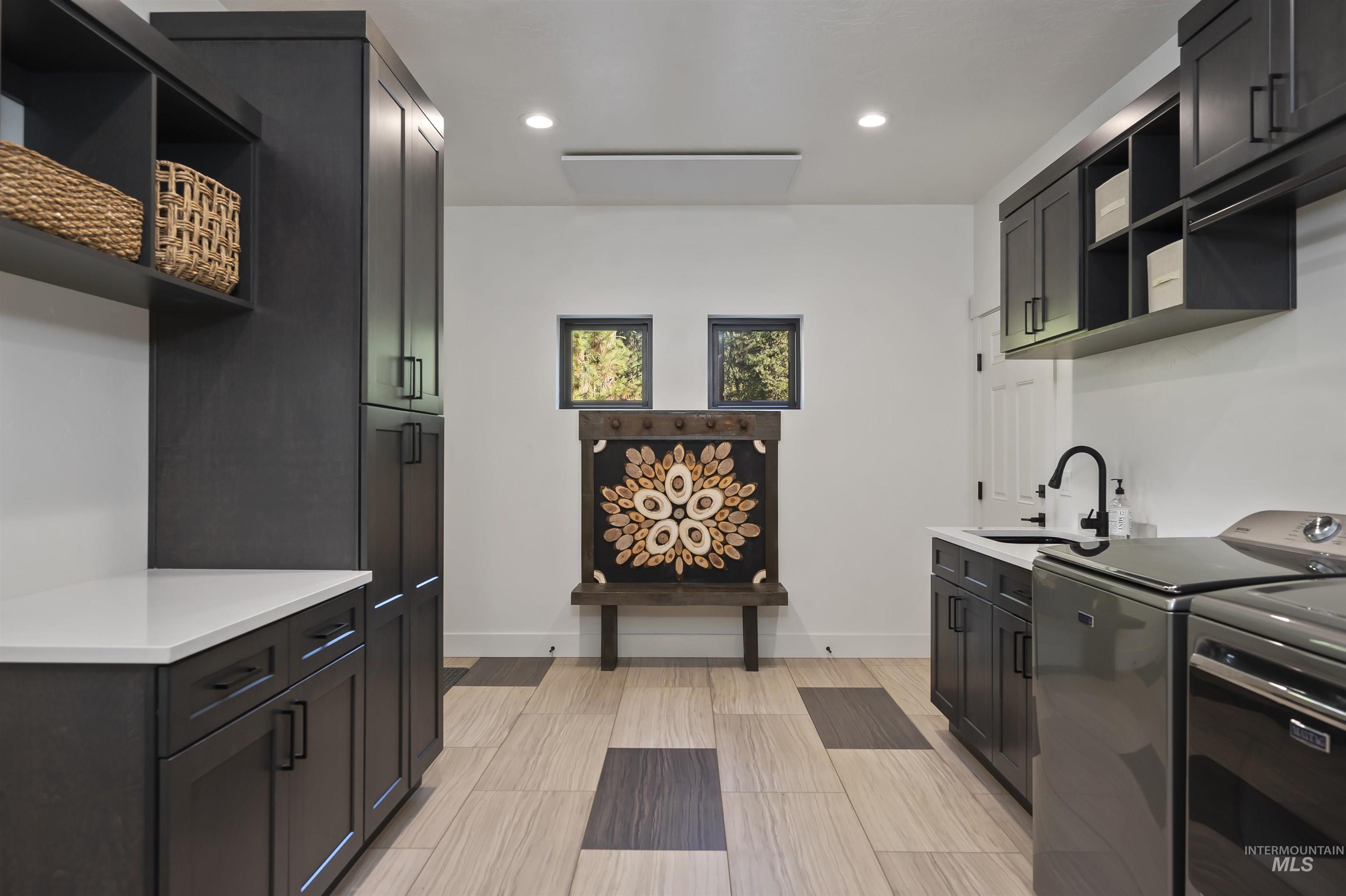 Kitchen with open shelves, washing machine and dryer, recessed lighting, and light countertops