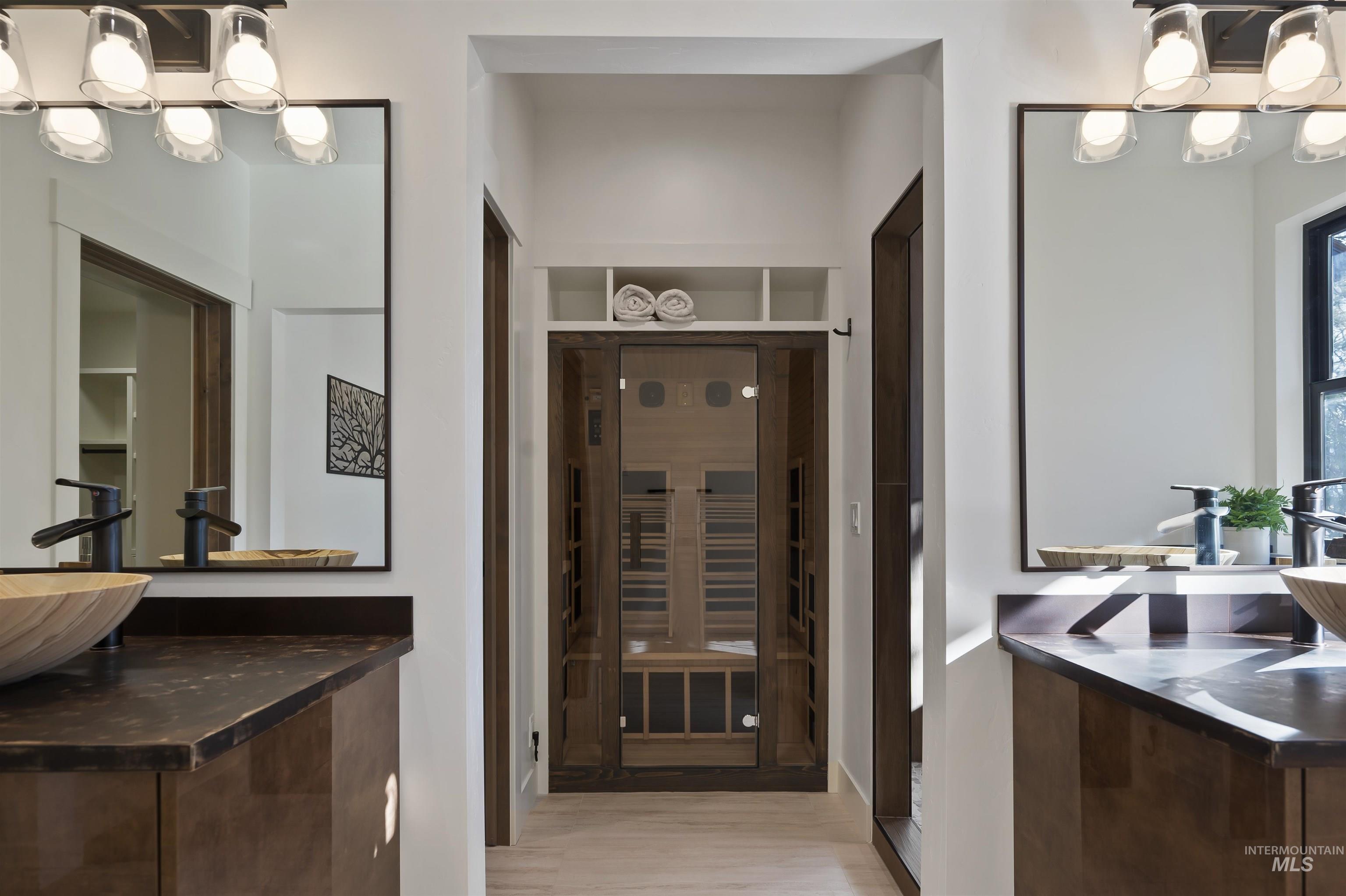 Bathroom with a chandelier and wood finished floors