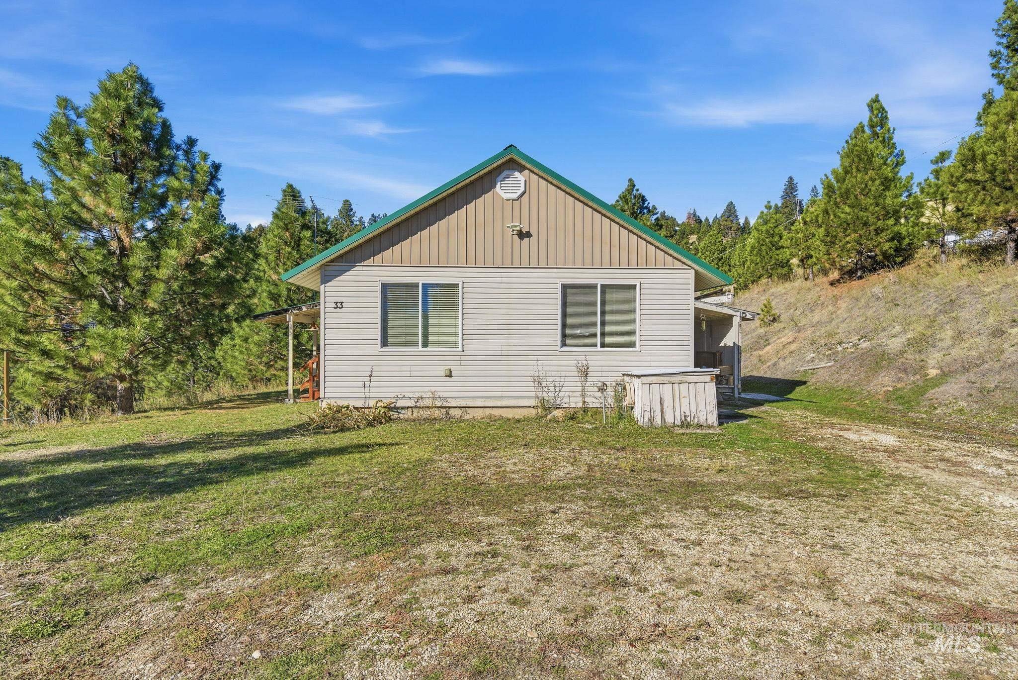 Rear view of property with a yard