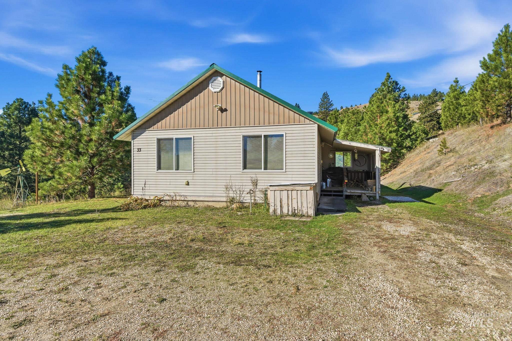 View of side of home featuring a yard and a wooden deck