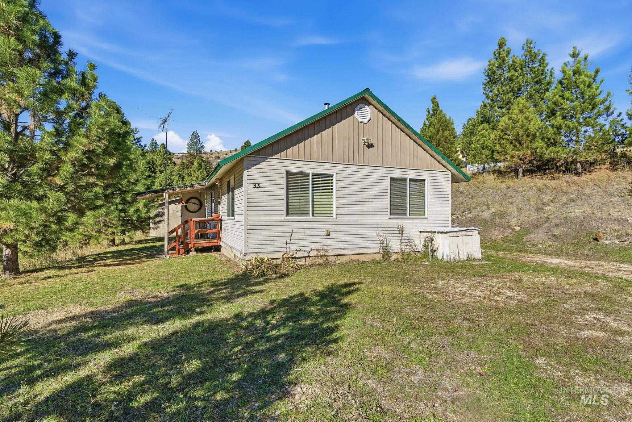 View of side of property featuring a lawn