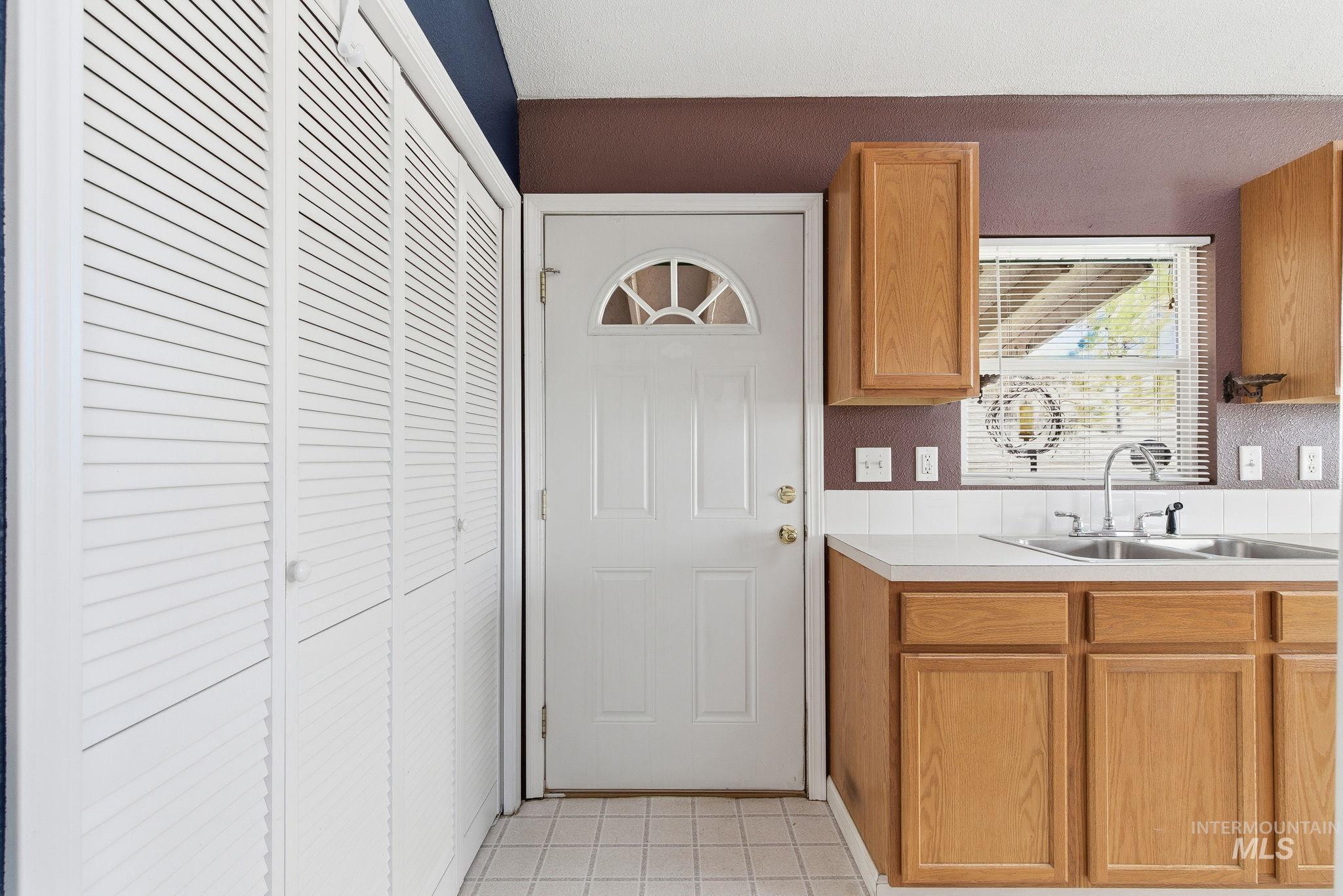 Kitchen featuring light countertops and brown cabinets