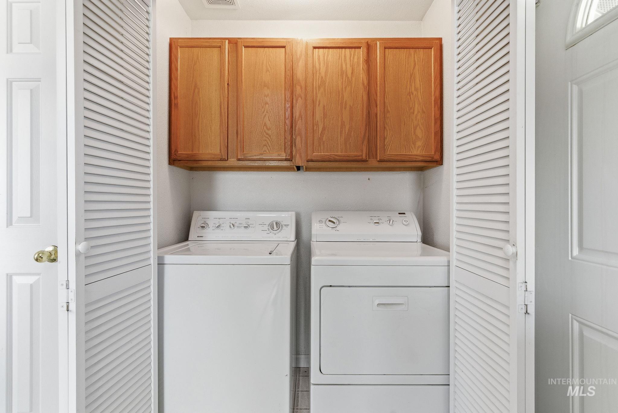 Laundry room featuring cabinet space and washing machine and clothes dryer