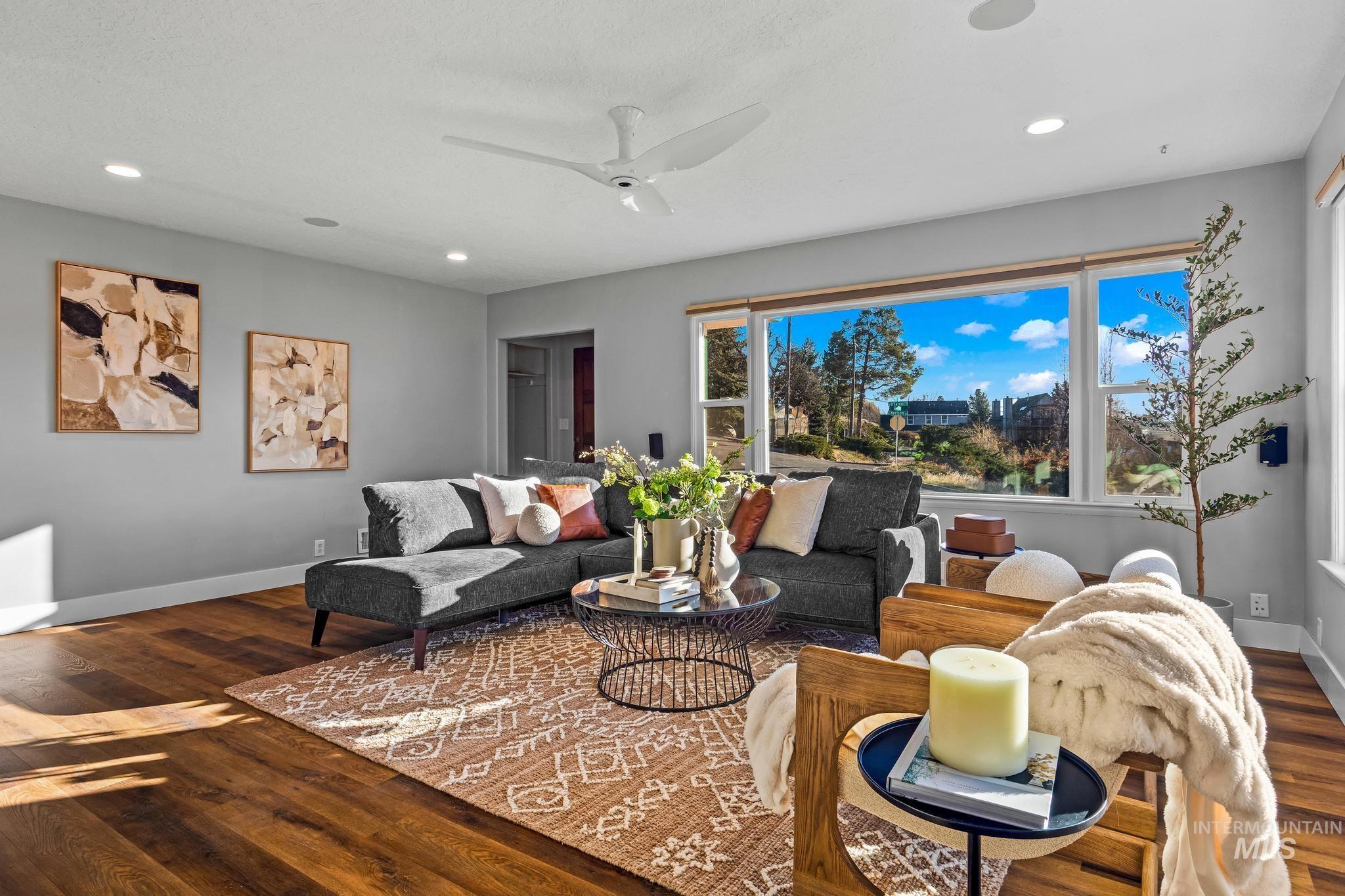 Living area with dark wood-style flooring, a ceiling fan, and recessed lighting