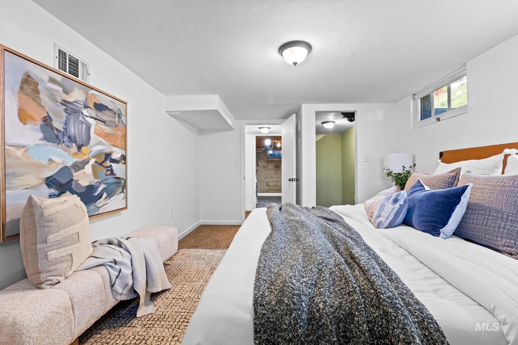 Bedroom with carpet floors and ensuite bath