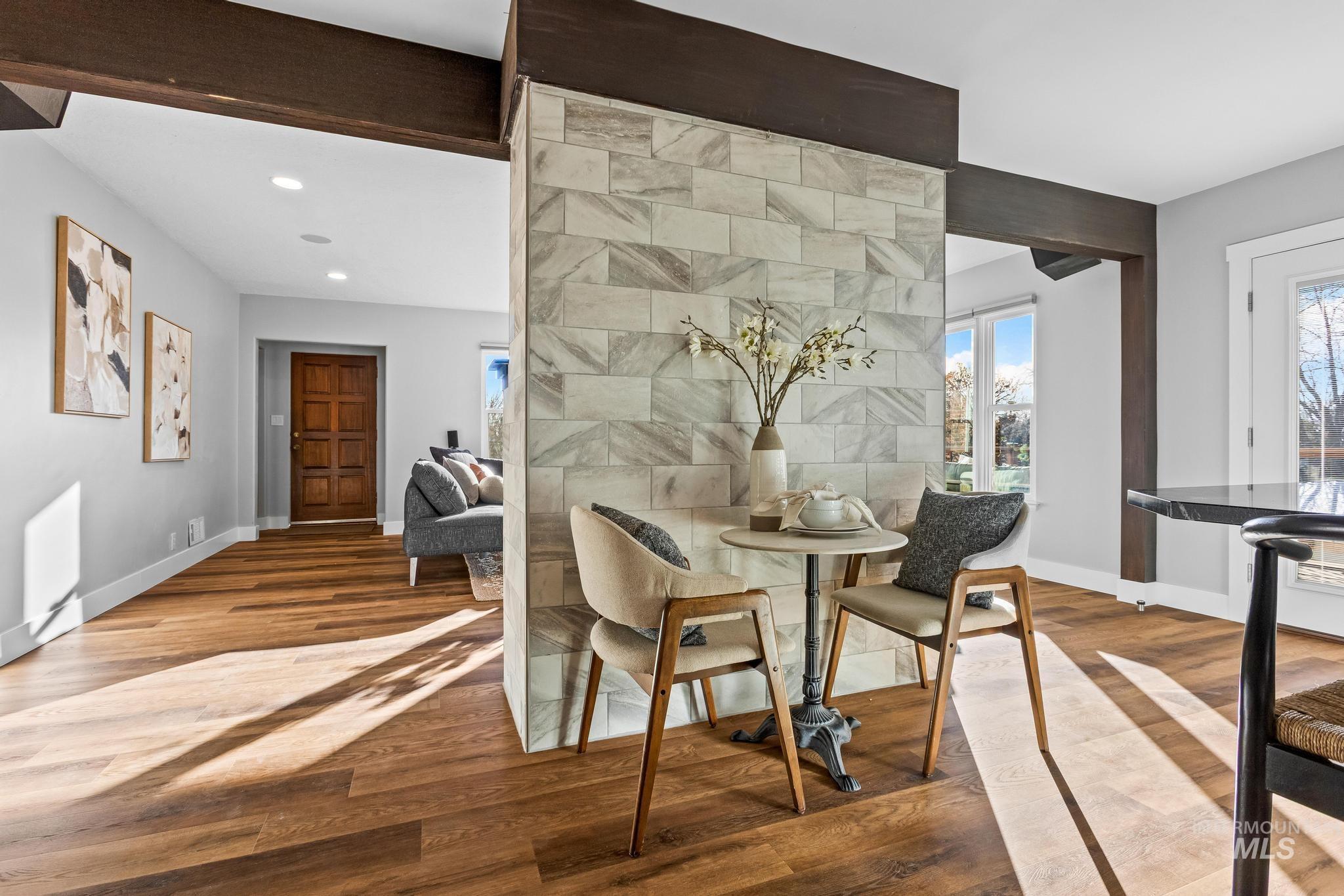 Dining space with wood finished floors, beamed ceiling, and recessed lighting