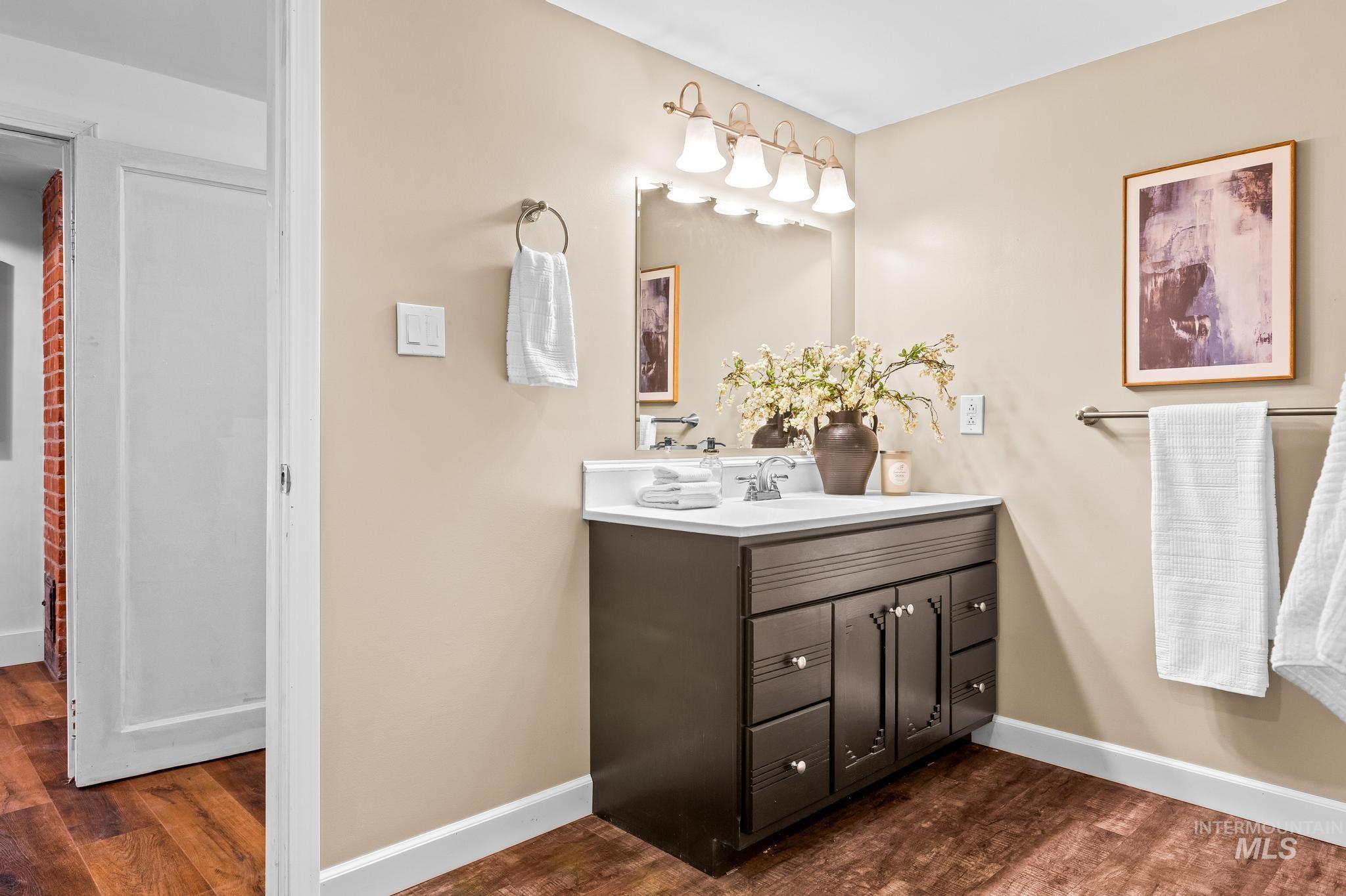 Bathroom with vanity and dark wood-style flooring