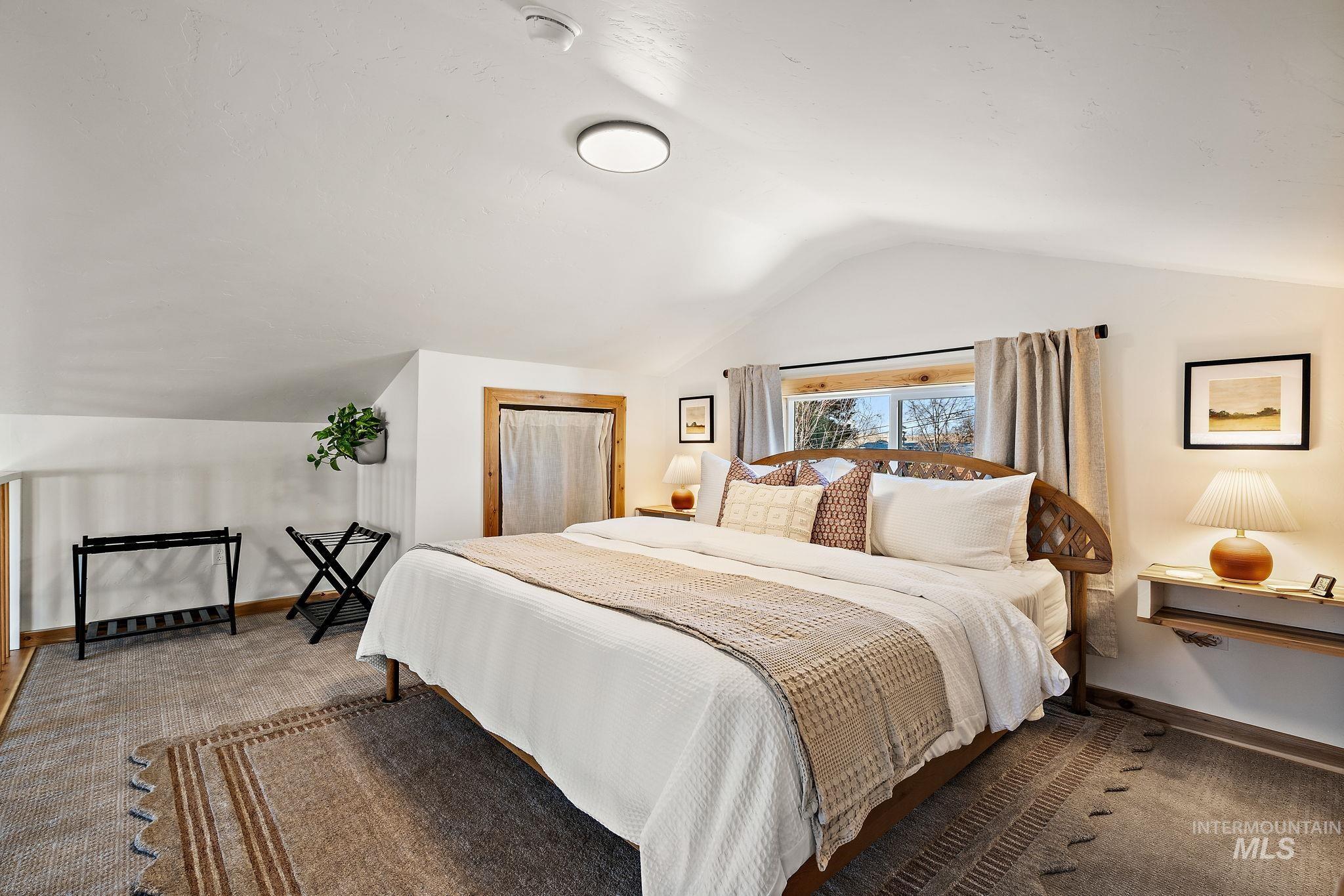 Bedroom with lofted ceiling and a closet