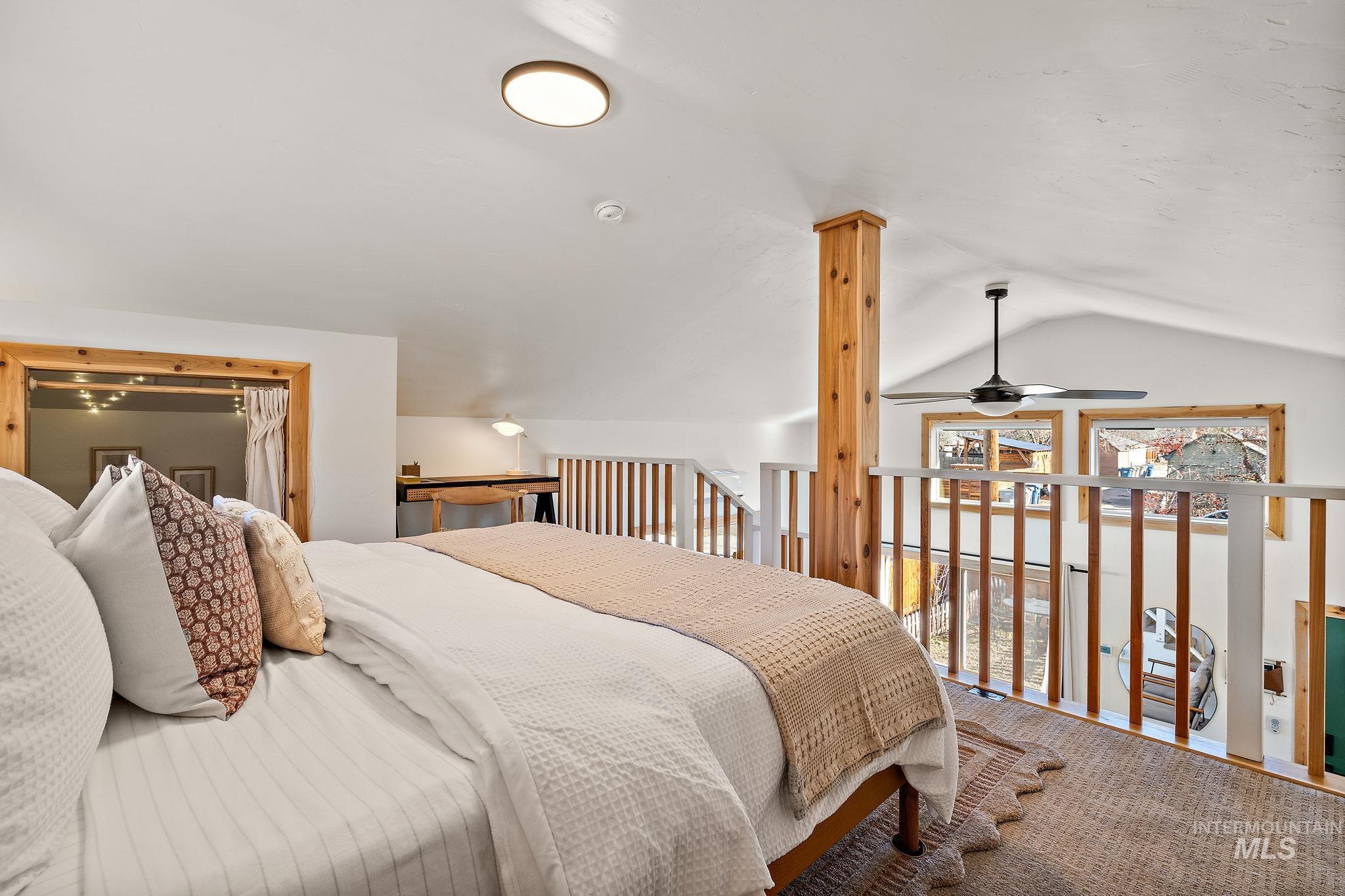 Bedroom with vaulted ceiling and carpet floors