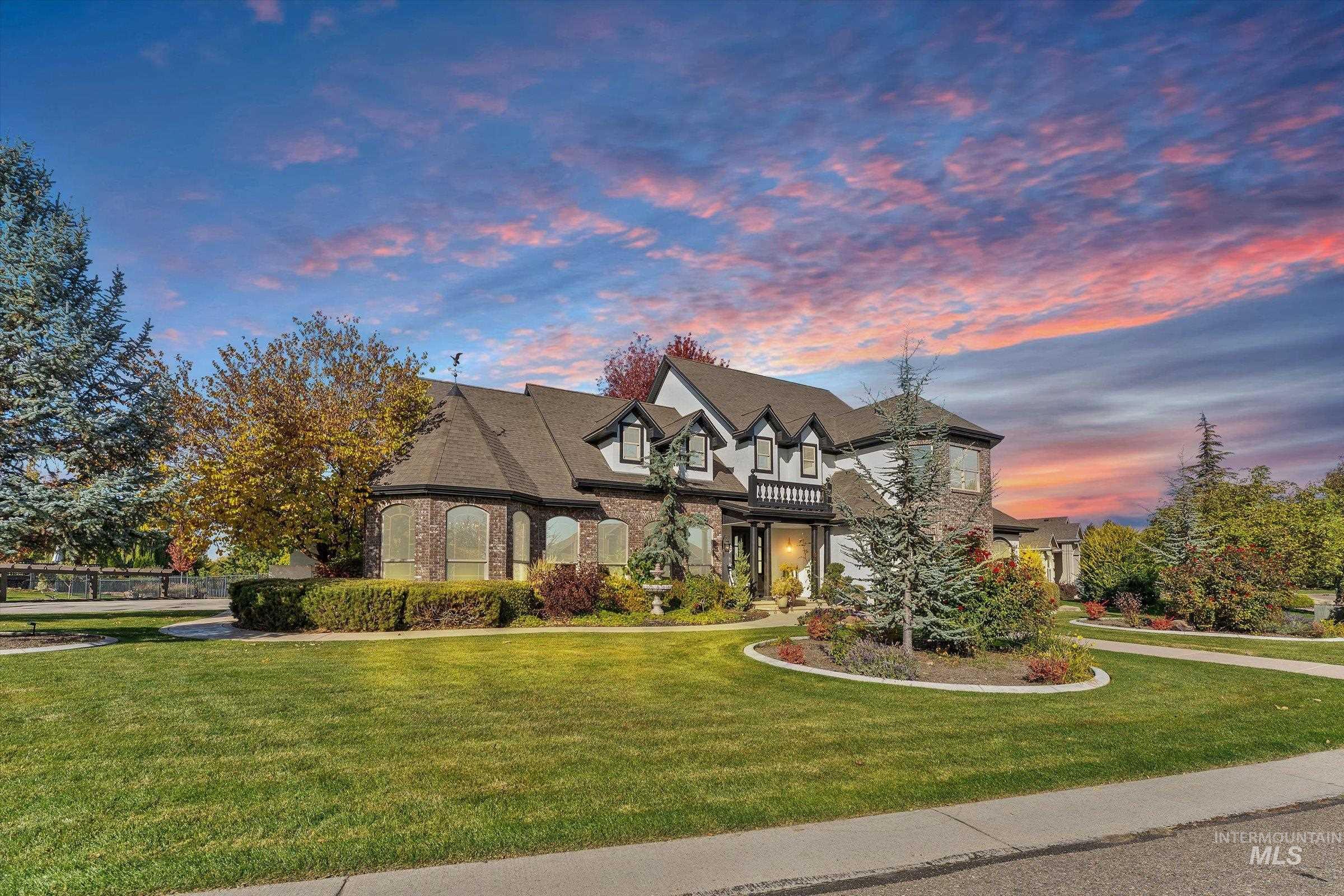 French country inspired facade with a front lawn and a balcony