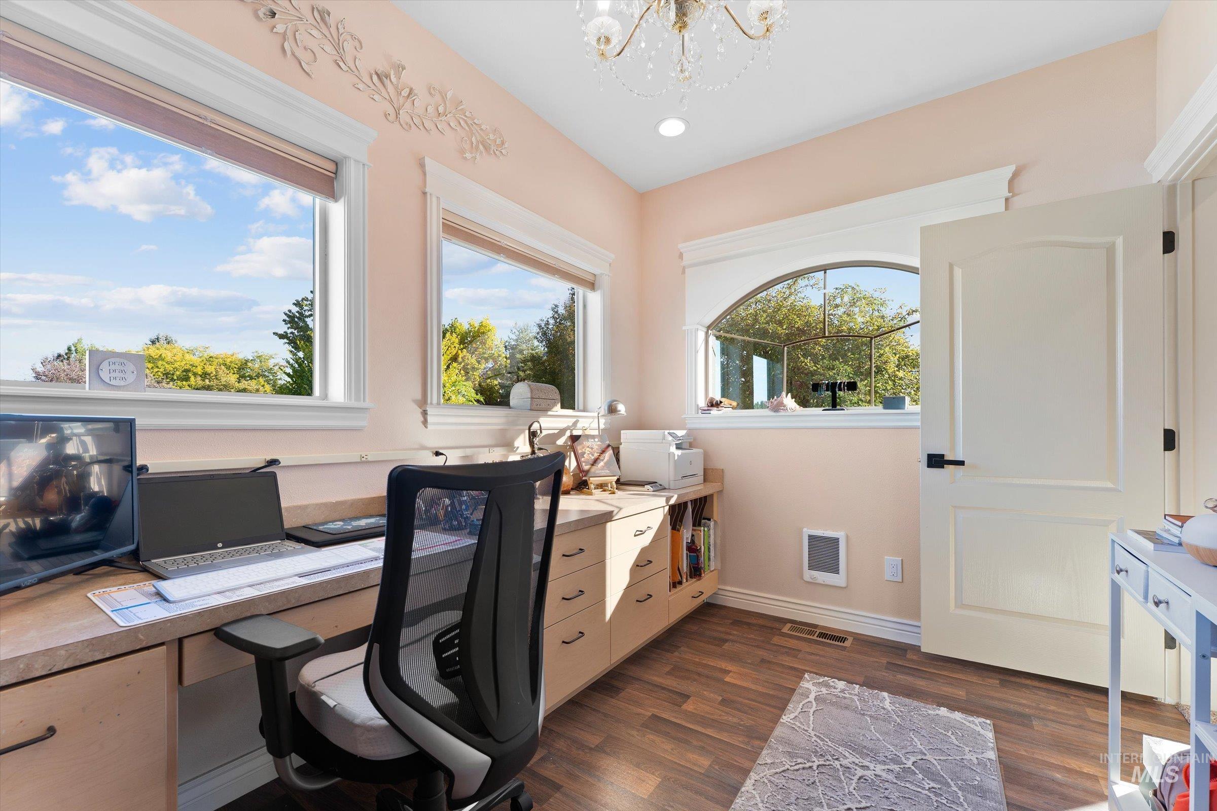 Office space featuring dark wood finished floors, a chandelier, heating unit, and recessed lighting