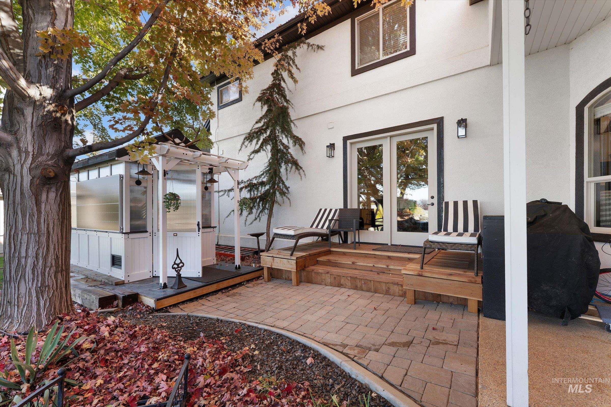 View of patio / terrace featuring a deck, an outdoor structure, area for grilling, and a greenhouse