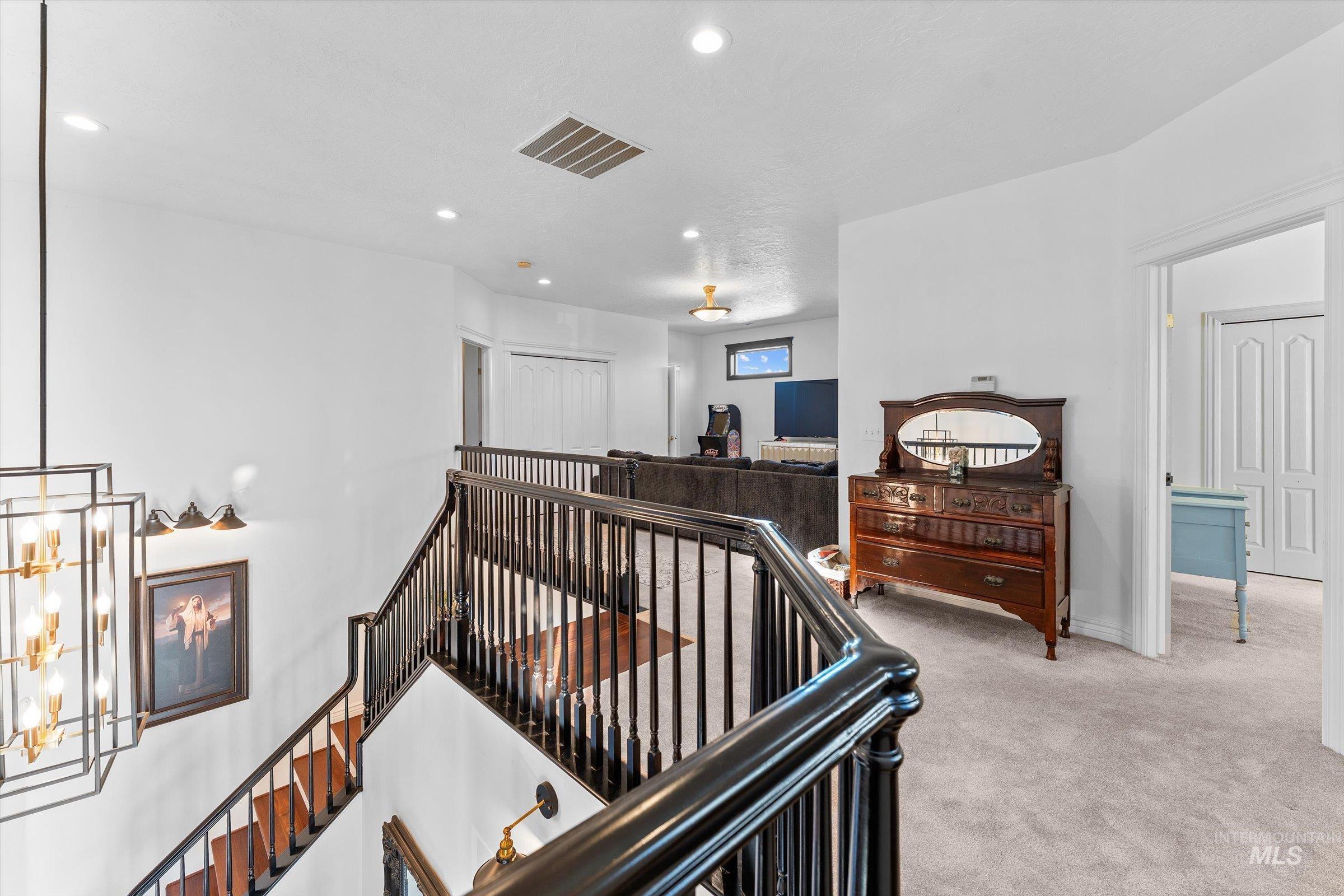 Stairs with carpet and recessed lighting
