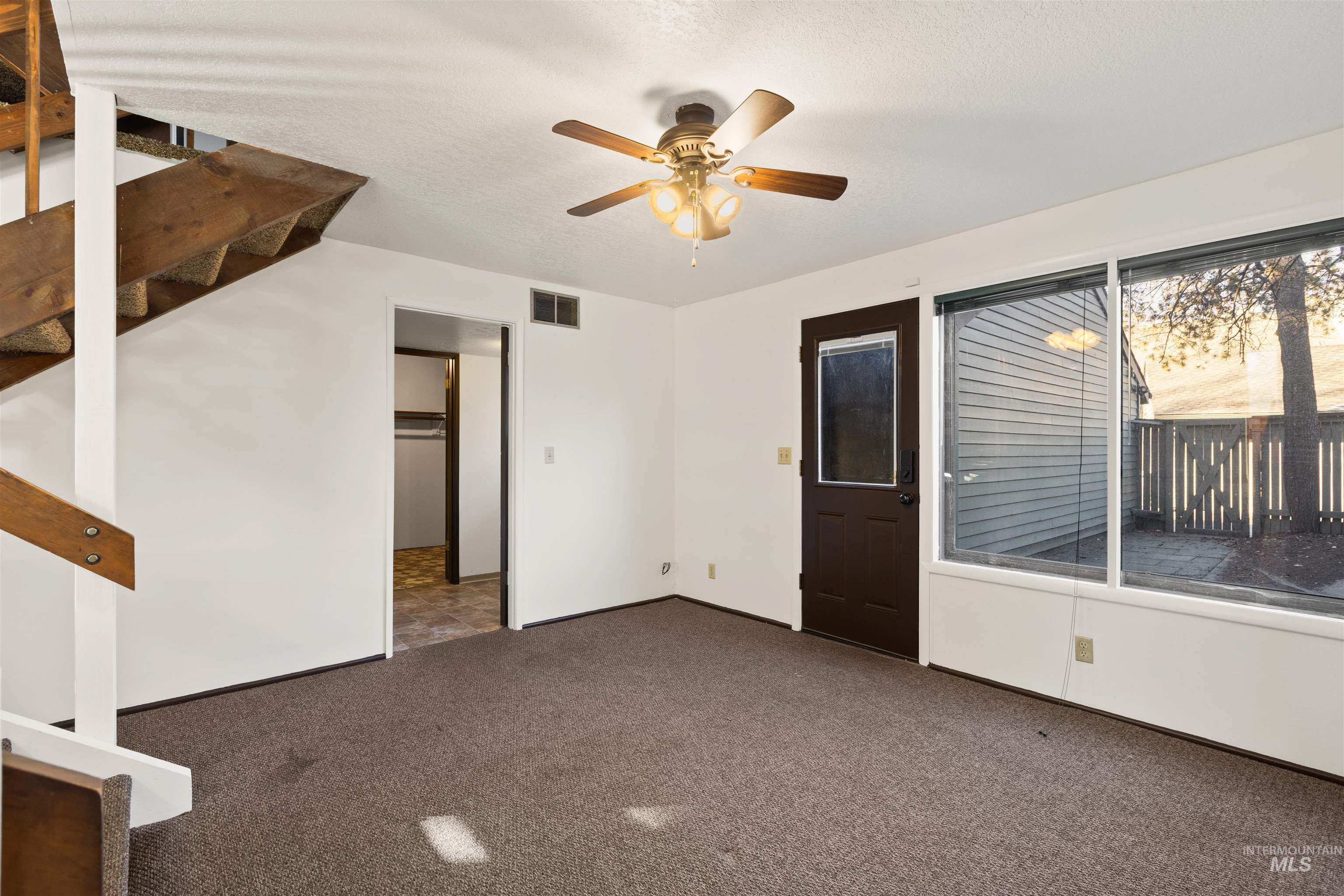 Unfurnished room with carpet floors and a textured ceiling